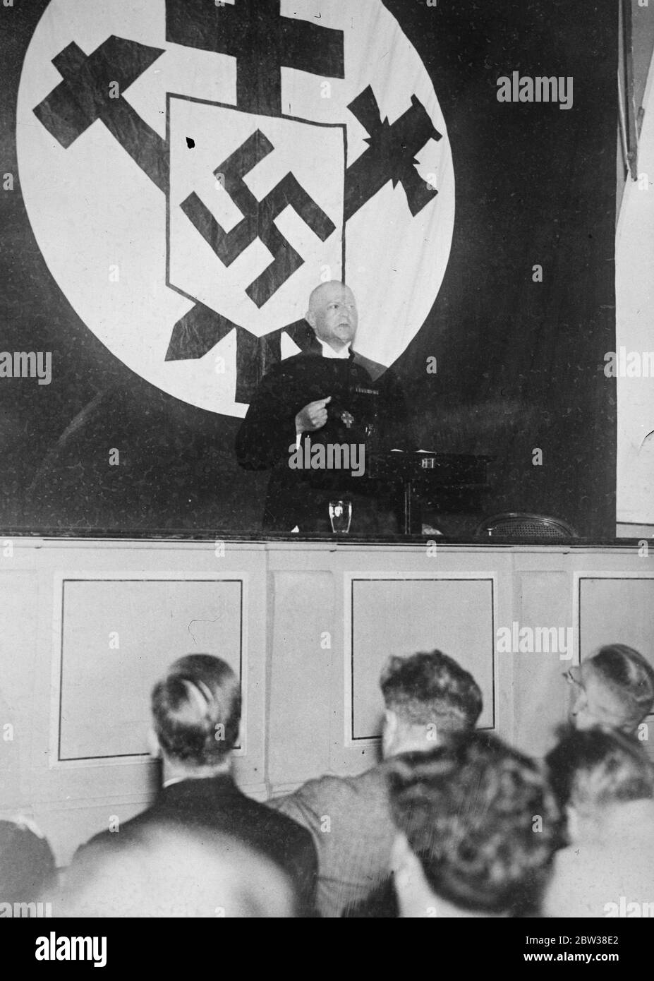 A supporter of Nazism gives a speech under the Nazi banner in Berlin . September 1934 Stock Photo