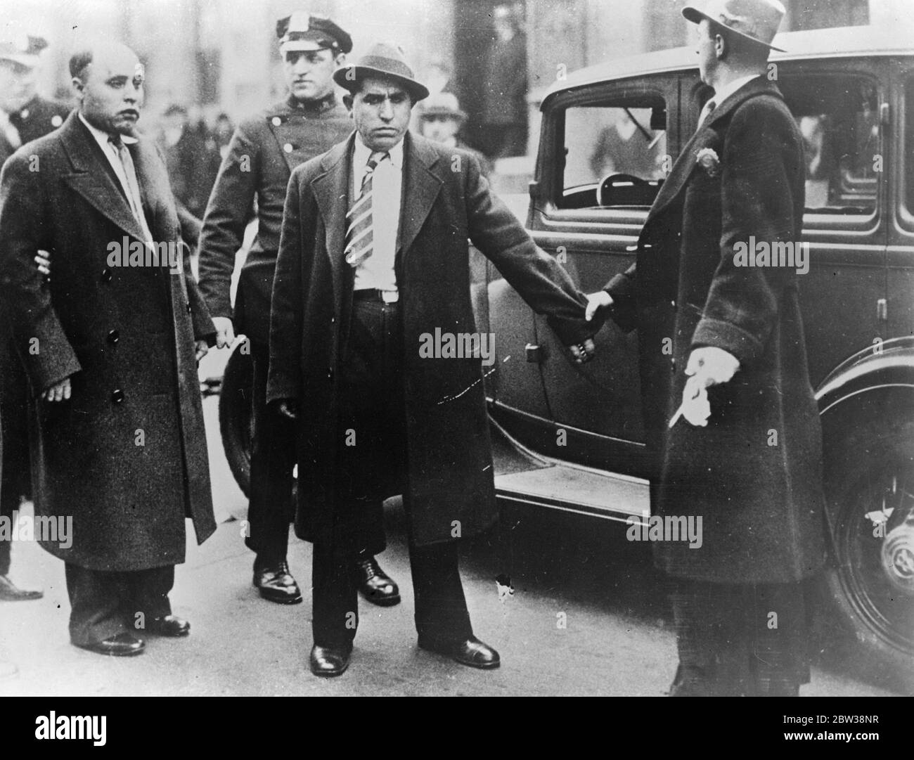 Arrested for murder of Armenian Bishop in New York . Tragedy visited the Holy Cross Armenian Catholic Church in New York when Archbishop Leon Touraine , head of that faith in the United States , was stabbed to death by a member of his congregation . The murder was the result of a dispute in the Church caused by the Archbishop ' s sponsoring the adoption of a new flag to replace the Armenian Banner . Photo shows ; the men who have been held by the police in connection with the murder . They are Matos Legletin ( left , hatless ) and Mishin Farkison ( striped tie ) . They were photographed immedi Stock Photo