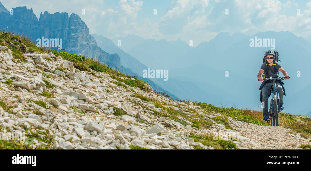 Sport and Recreation. Caucasian Men Riding on Mountain Bike. Scenic