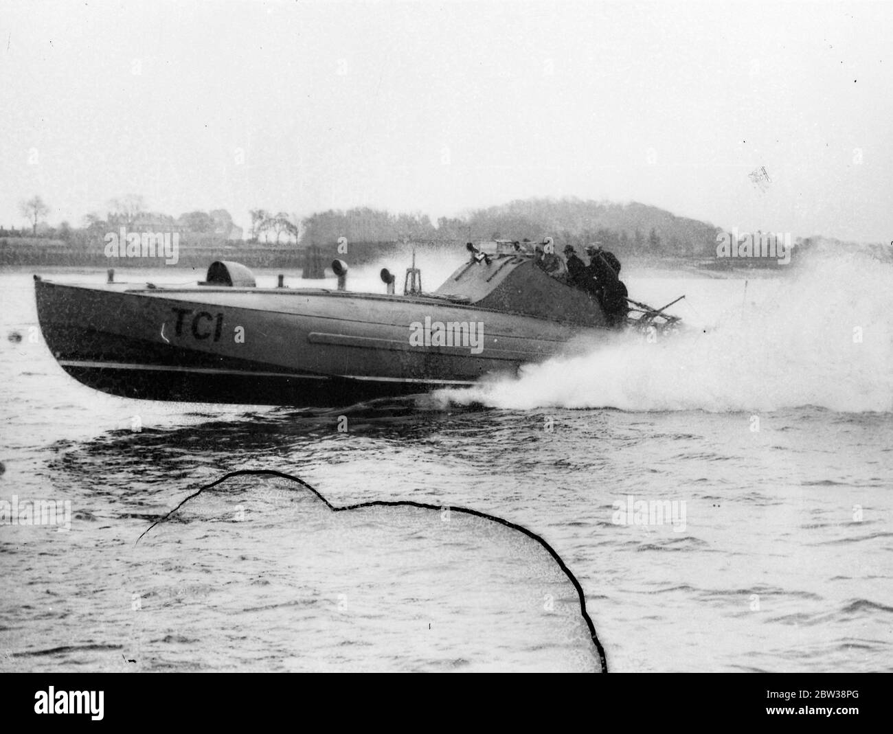 Britain produces new midget torpedo boat , which can attack submarines , aircraft , and warships . Many countries are taking great interest in the new midget torpedo boats which are being built by Thornycrofts , a British firm . The midget torpedo boat is a descendant of the coastal motorboat which were responsible for some of the most audacious operations of the war . The ideal size is 55ft boat which can skim the water at 40 knots , and carries two torpedoes , two small anti aircraft guns , four depth charges , smoke screen apparatus and a wireless telephone cabinet which keeps it in convers Stock Photo
