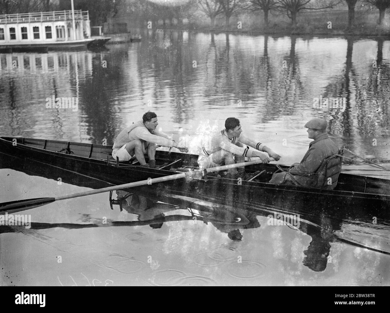 Boat race practice in full swing . The Oxford crew had an outing on the Isis during preparations for the boat race against Cambridge . The general opinion is that this year ' s crew will be the best that has represented Oxford since the war . Photo shows ; A K Kitchin , the Oxford coach , out tubbing with V Sutcliffe ( stroke ) and P R S Bankes . 9 January 1934 30s, 30's, 1930s, 1930's, thirties, nineteen thirties Stock Photo