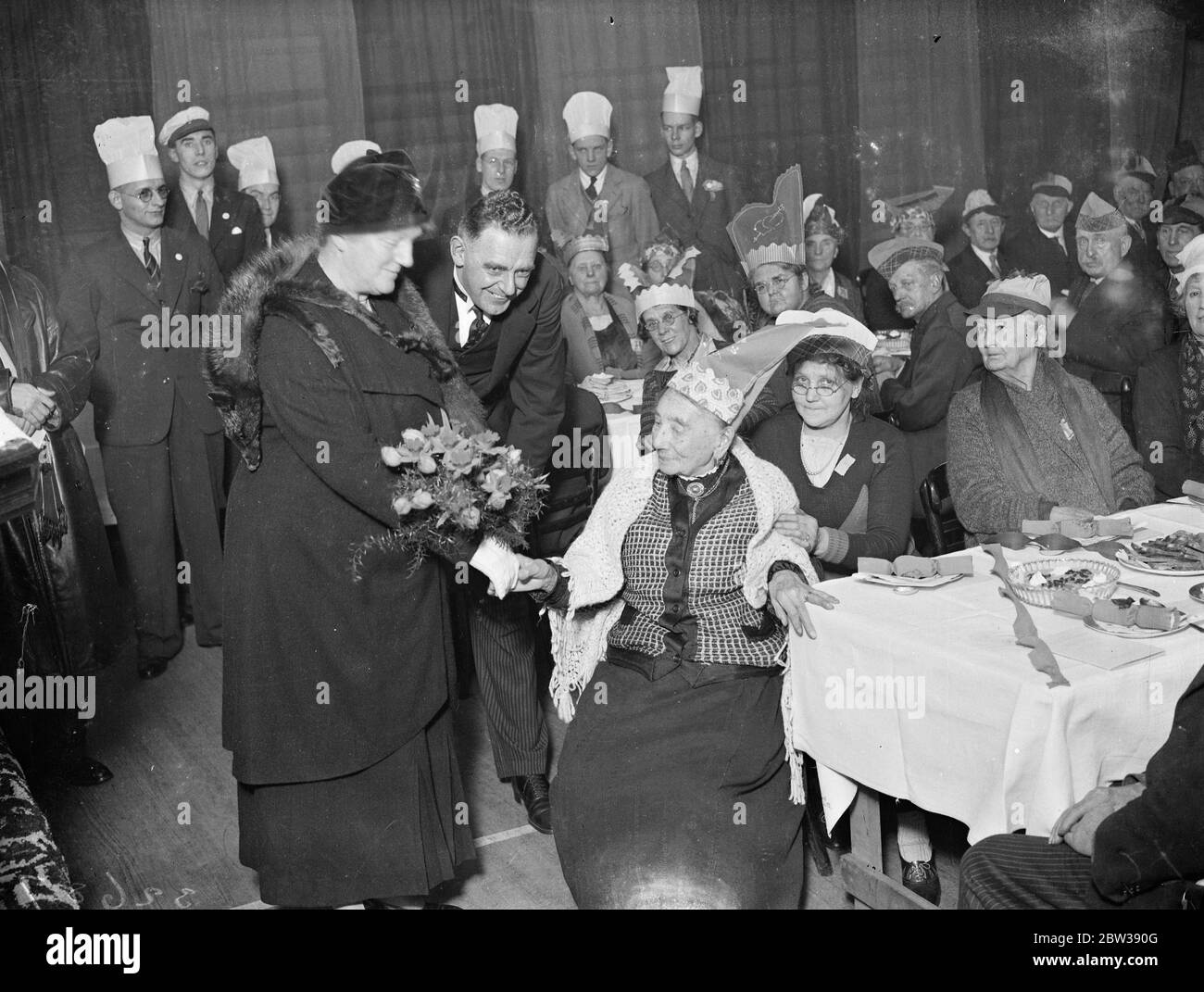 Hornsey ' s oldest inhabitant presents bouquet to Lady Mayoress . The oldest inhabitants in the district were entertained to tea at the Hornsey , London . YMCA - the Lady Mayoress of London , Lady Collett , attended . Photo shows ; Hornsey ' s oldest woman resident , Miss Mary Ashley , aged 99 , presenting a bouquet to the Lady Mayoress . 13 January 1934 30s, 30's, 1930s, 1930's, thirties, nineteen thirties Stock Photo