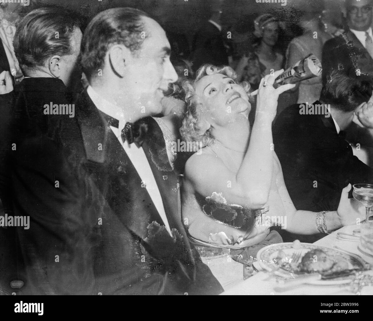 Betty Compson celebrates at a  wild  Hollywood party . Betty Compson , the film actress in a jocular mood while attending a  wild  Hollywood party , with Irving Weinberg . 18 March 1933 30s, 30's, 1930s, 1930's, thirties, nineteen thirties Stock Photo