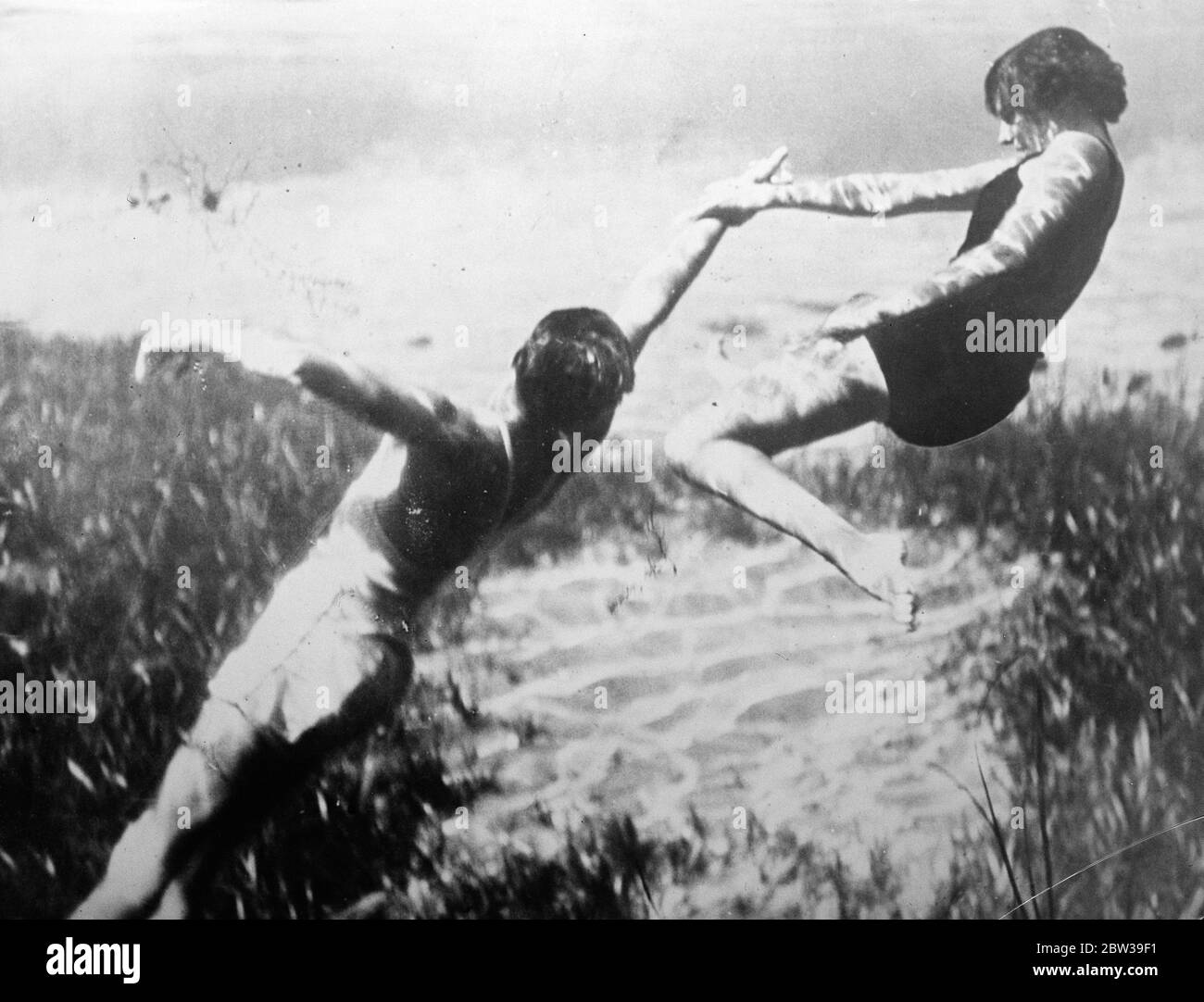 Watching a life saver at work . One of a series of thrilling under water pictures made by the Red Cross Society of America to demonstrate life saving methods , at Silver Springs , Florida , a spot noted for its clear water . 25 July 1935 Stock Photo
