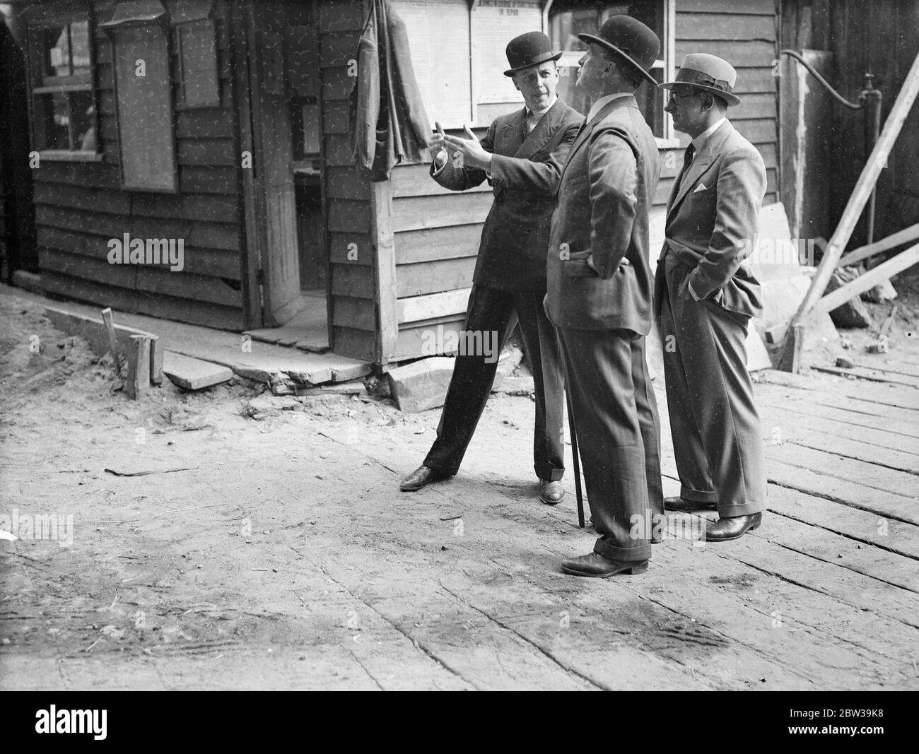 Europe 's largest block of flats will have bomb proof shelter at Albany Street and Euston Road . Left to right - Mr M J T Goudie , the owner of the building , Colonel Gorforth of the Home Office , and Mr A E Parkinson , director of Sir Lindsay Parkinson , Ltd , the contractors , discussing the bomb proof shelter on the site . 25 July 1935 Stock Photo