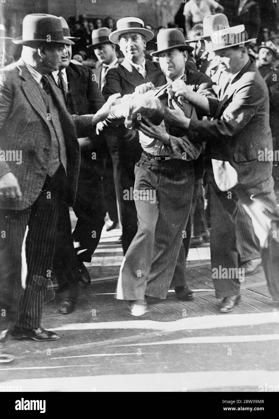 More than a thousand arrests in Paris anti wage cut riots - police in fierce battles with demonstrators . An arrested demonstrator struggling to get free in the Boulevard Haussmann . 20 July 1935 Stock Photo