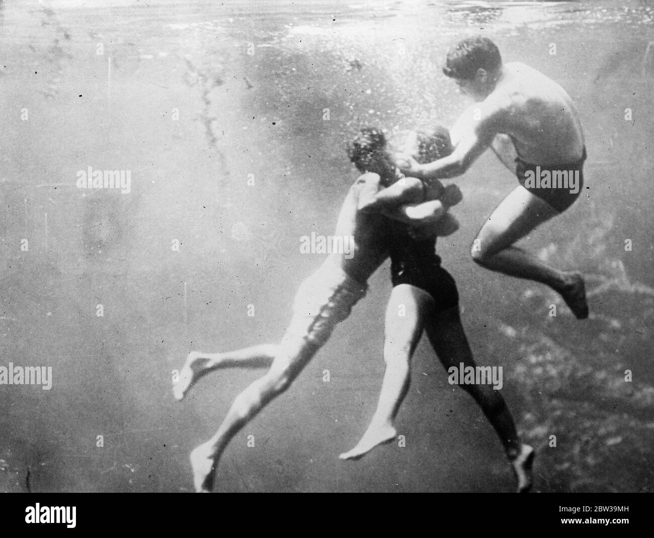 Watching a life saver at work . One of a series of thrilling under water pictures made by the Red Cross Society of America to demonstrate life saving methods , at Silver Springs , Florida , a spot noted for its clear water . 25 July 1935 Stock Photo