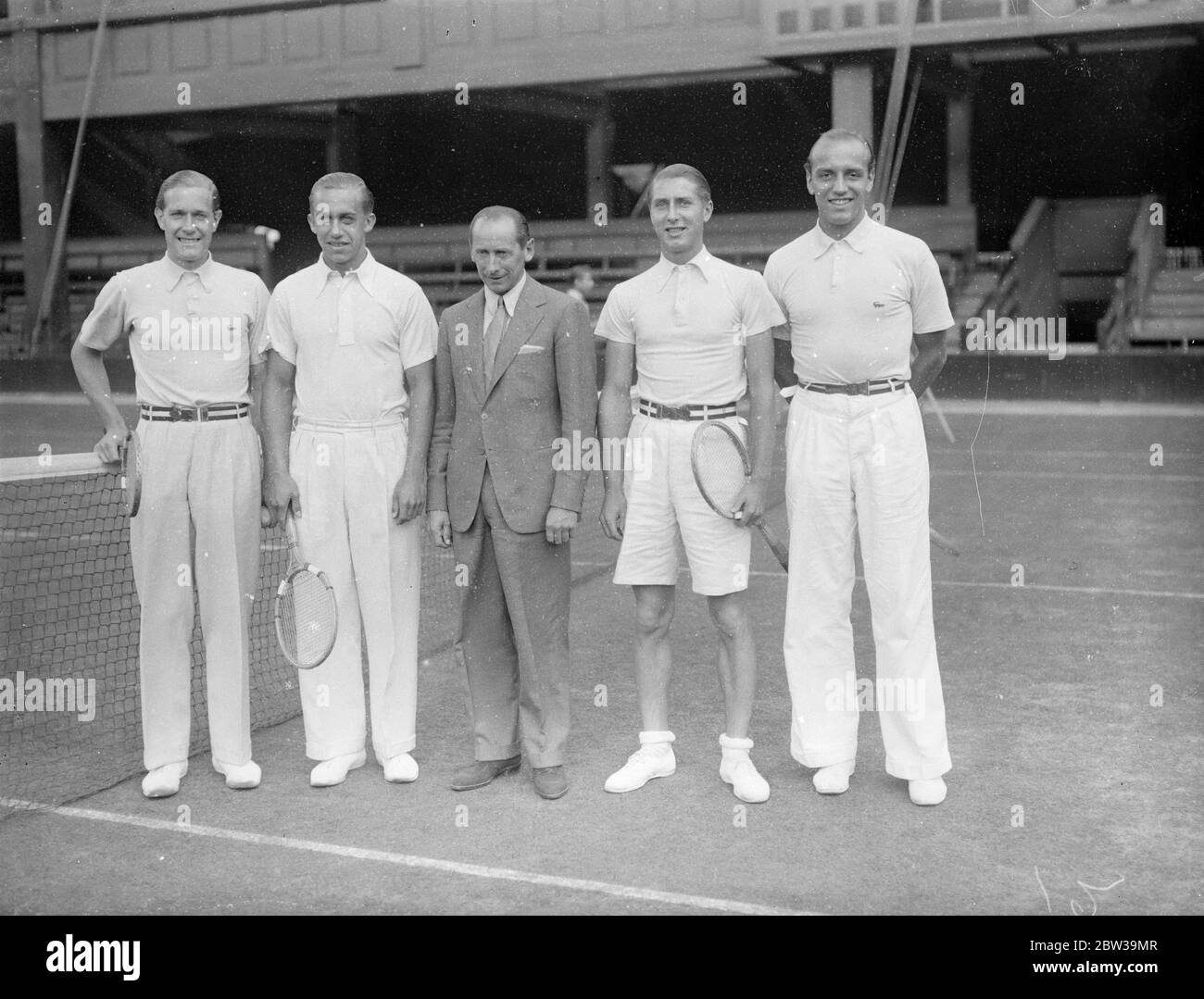 German Davis Cup team practises at Wimbledon for inter zone matches . The German Davis Cup team photographed at Wimbledon . Left to right - Baron von Cramm , H Henkel , H Denker and K Lund . 18 July 1935 Stock Photo