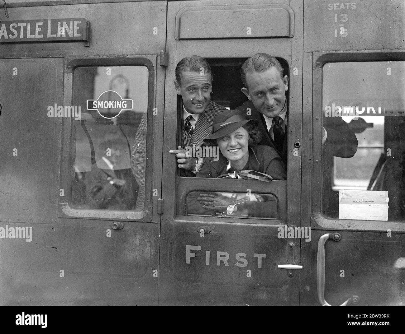 Jack Crawford and Adrian Quist ( left ) the Australian Davis Cup players and Mrs Crawford left Waterloo station on the Warwick castle boat train for South Africa . July 1935 Stock Photo