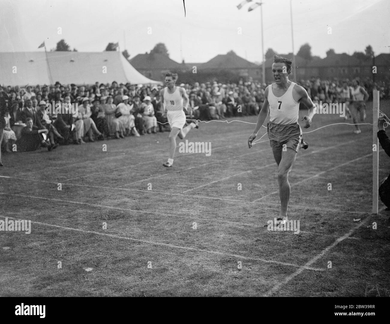 Paris schoolboy athletes meet London team for first time at Rutlish school , Merton , London . Photo shows ,Andre Dumas coming 2 in the 440 yard dash . 26 July 1935 Stock Photo