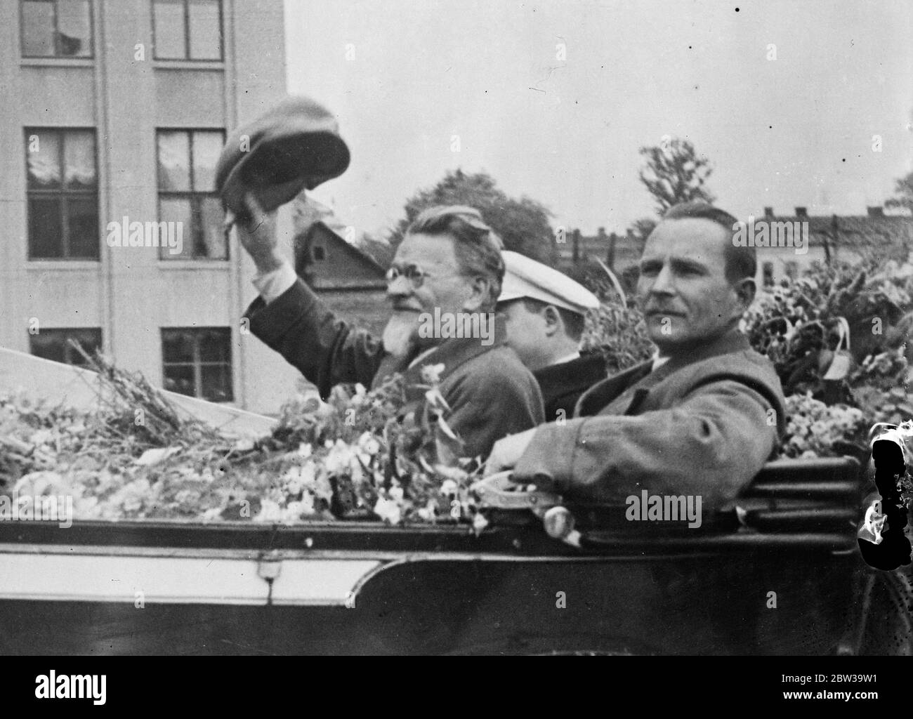 Kalinin joins in 15th anniversary celebrations of Soviet White Russia . Mikhail Kalinin acknowledging the crowd 's greeting in Minsk . With him ( right ) is M Goloded , chairman of the Council of Peoples Commissars of the White Russian Soviet . 19 July 1935 Stock Photo