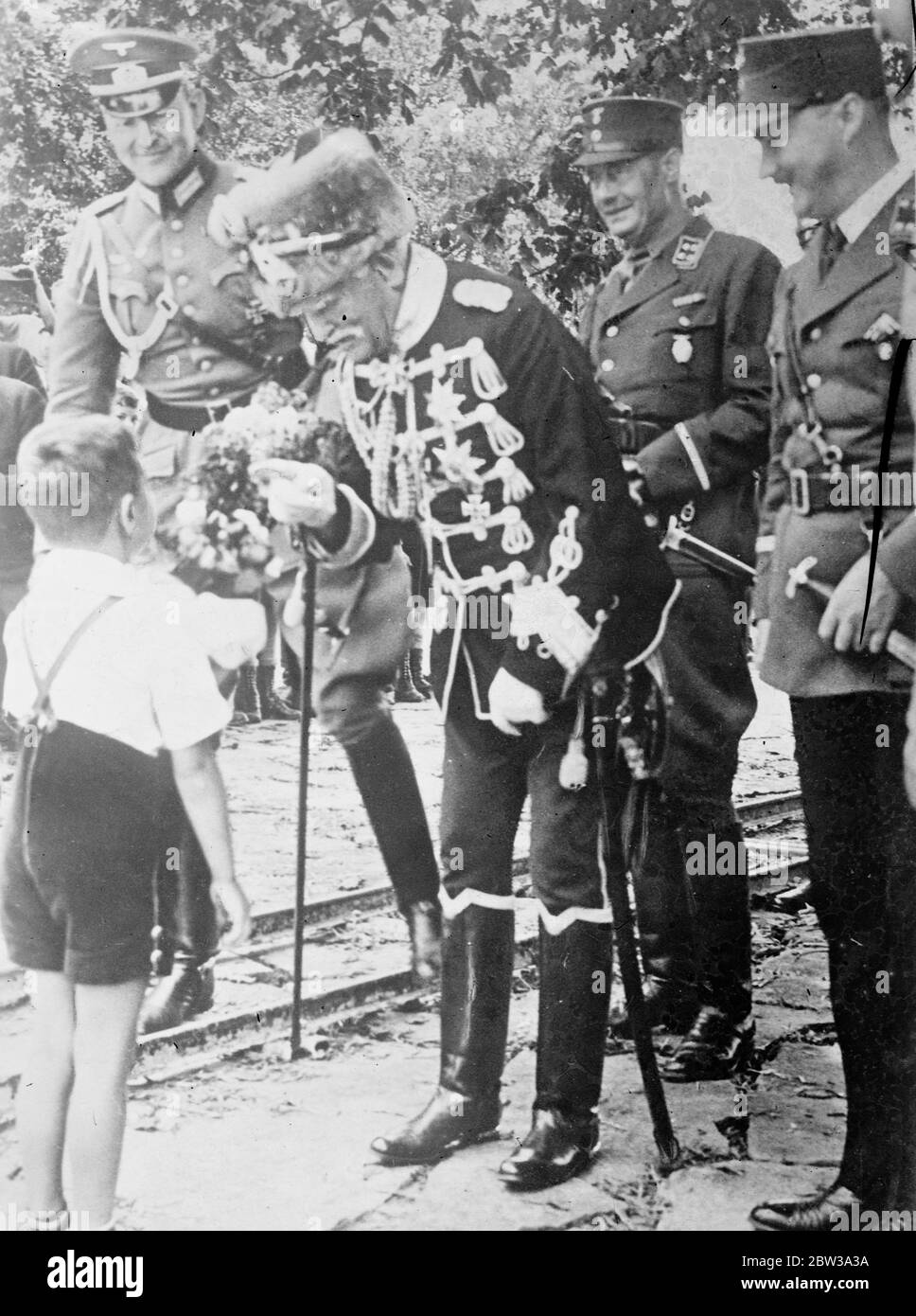 Field Marshal von Mackensen . State visit to the German fleet at Bremen . Photo shows Field Marshal von Mackensen chats to a little boy who presented him with a bouquet of flowers . 1 July 1935 Stock Photo