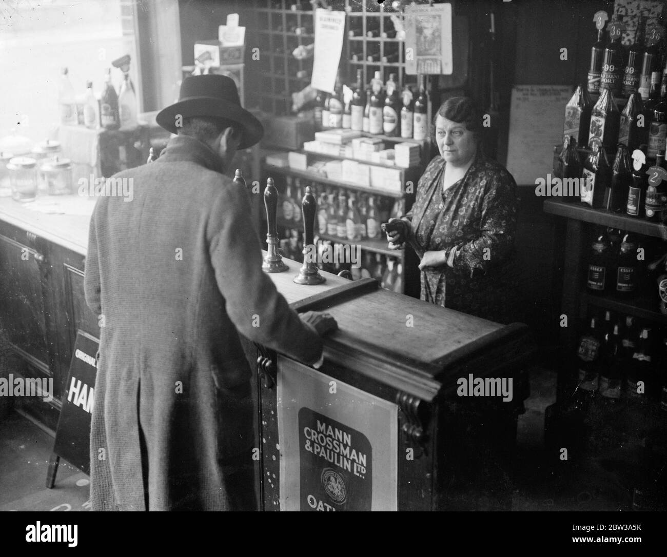 Woman routs armed bandits with fake pistol at London shop . Miss Alice Lloyd , proprietress of the Sidney Wine Stores in Sidney Road . Homerton , London , beat off three men , one armed with a revolver , who walked into her shop and demanded money . Miss Lloyd ' s sole weapon was a novelty cigarette case in the shape of an automatic pistol . Miss Lloyd was in the shop with a friend when three men strode in and their leader presented a revolver at the two women . His two companions had bolted the door . The man with the revolver demanded money , and Miss Lloyd dashed into her inner room and gra Stock Photo