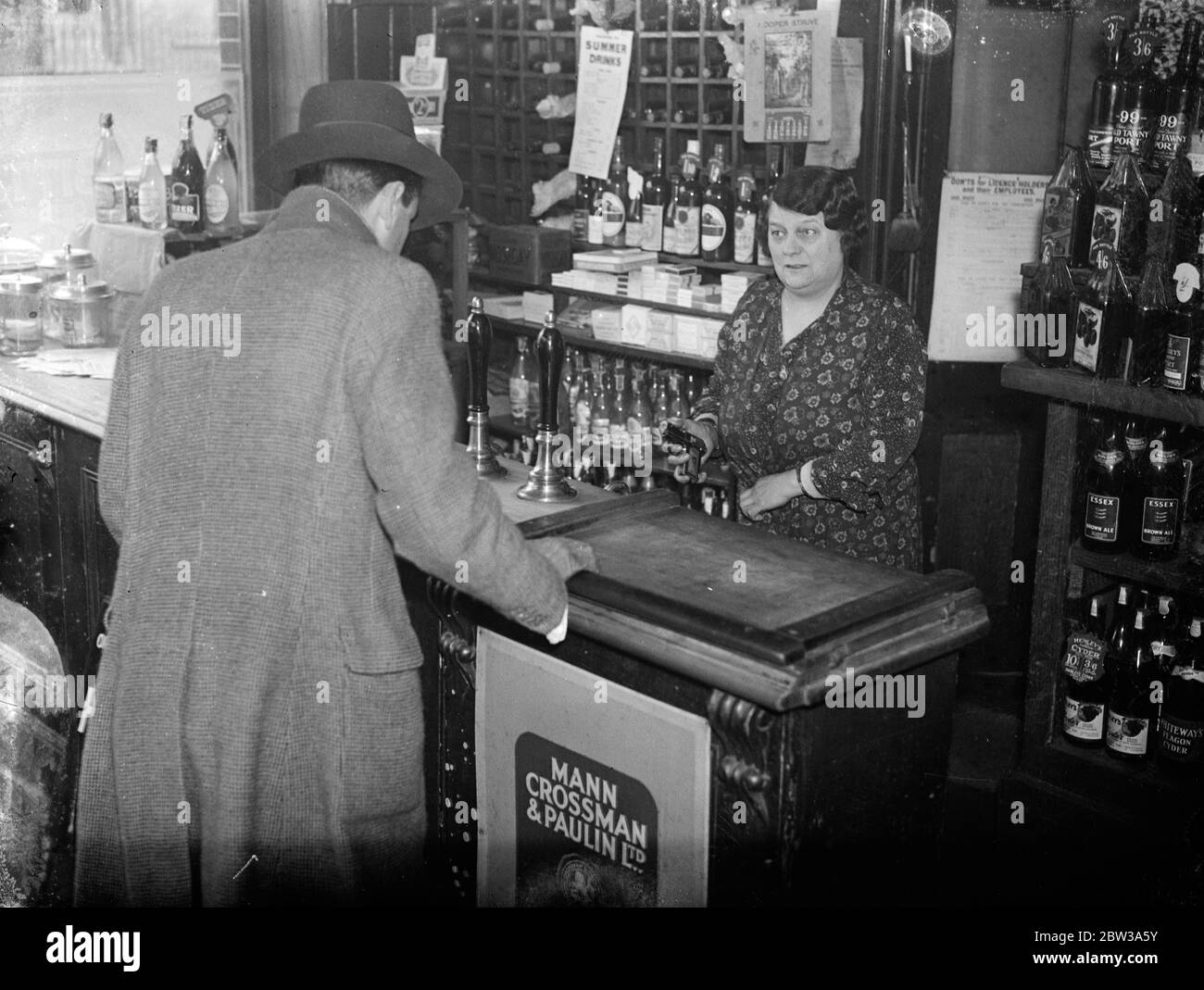 Woman routs armed bandits with fake pistol at London shop . Miss Alice Lloyd , proprietress of the Sidney Wine Stores in Sidney Road . Homerton , London , beat off three men , one armed with a revolver , who walked into her shop and demanded money . Miss Lloyd ' s sole weapon was a novelty cigarette case in the shape of an automatic pistol . Miss Lloyd was in the shop with a friend when three men strode in and their leader presented a revolver at the two women . His two companions had bolted the door . The man with the revolver demanded money , and Miss Lloyd dashed into her inner room and gra Stock Photo