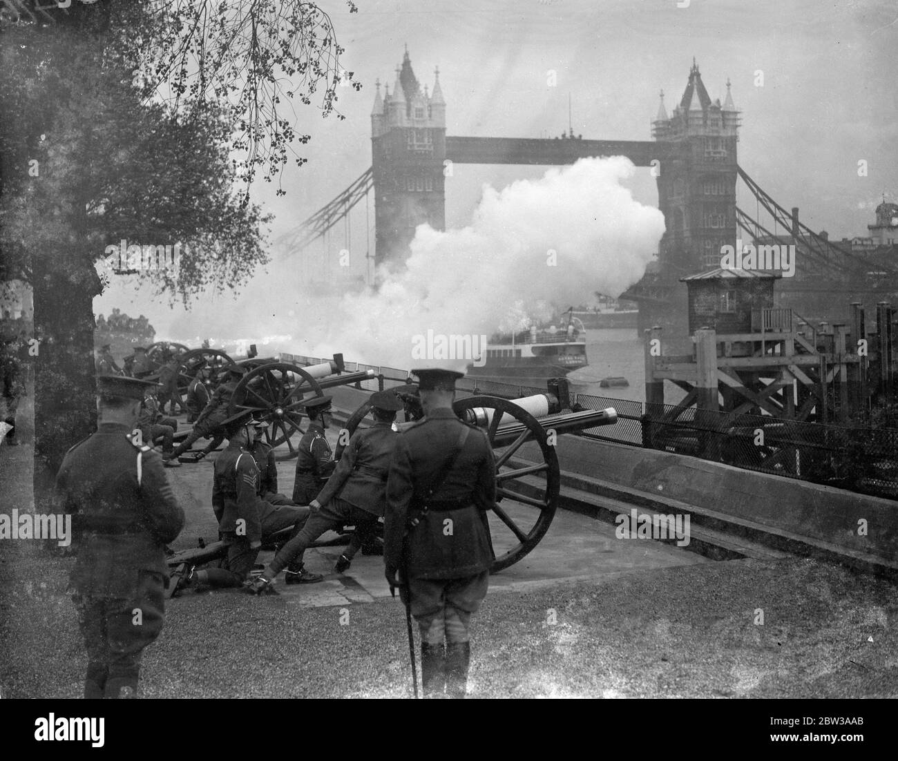 A salute of twenty - one guns was fired at the Tower of London to mark the 24th anniversary of the King ' s accession to the throne . Photo shows firing the salute at the Tower . 7 May 1934 Stock Photo