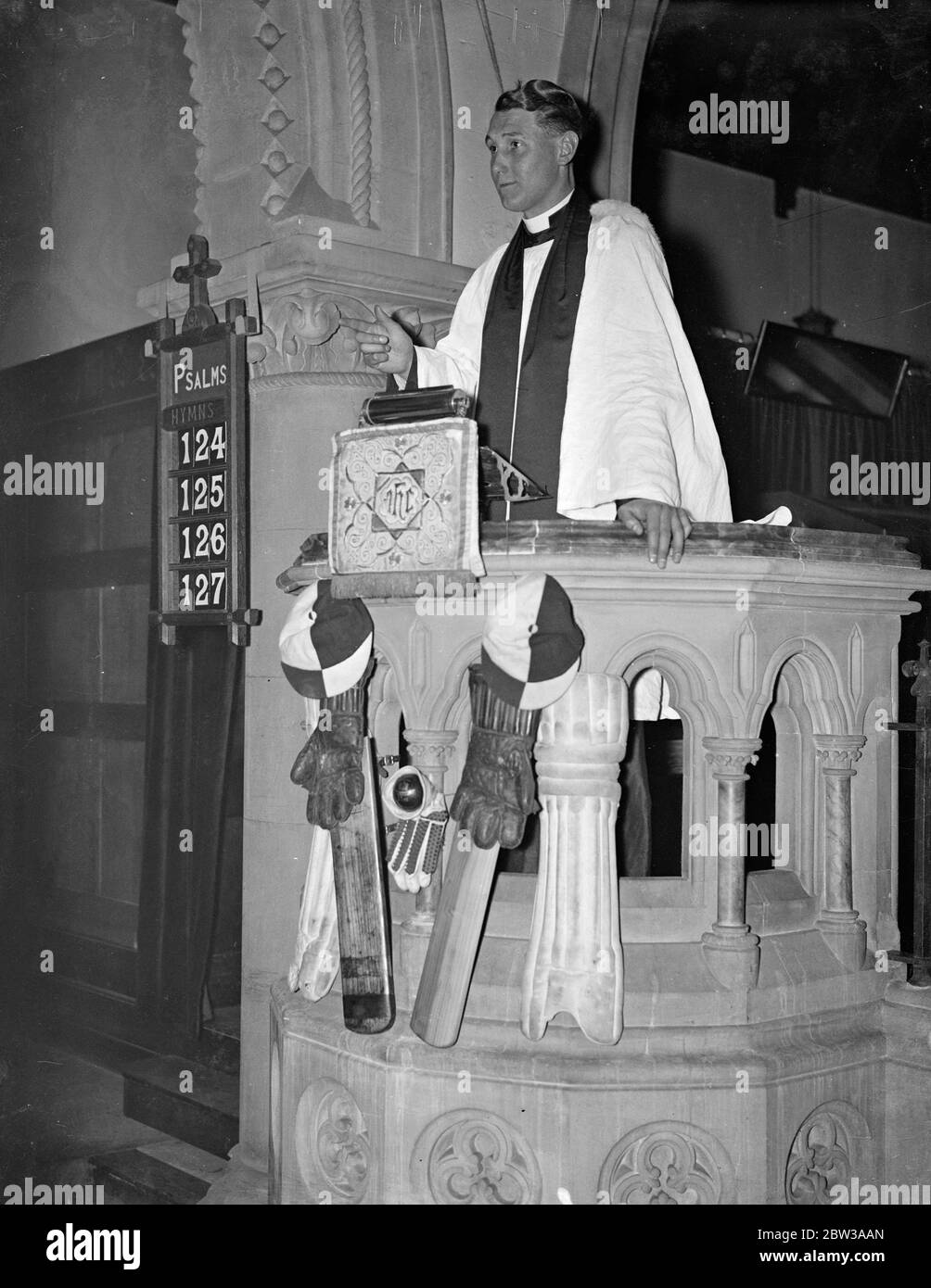 Pulpit decorated with cricket bats and pads at sportsman ' s service . The pulpit at St Saviours Church , Herne Hill , London , was decorated with cricket bats and pads , at a special service attended by a large number of sportsmen from all over South London . The service was conducted by the Rev G Blacktop of Roselyn Park , Surrey . Photo shows the Rev G Blacktop preaching from the decorated pulpit . 2 April 1934 Stock Photo