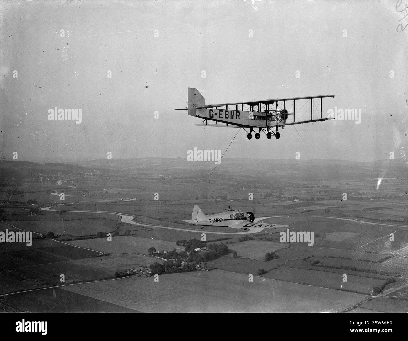 Sir Alan Cobham made a mid air refuelling test at Portsmouth in preparation for his non-stop flight to India on September 21st . His aeroplane , an ' Airspeed Courier ' is a monoplane fitted with a 240 Hp Armstrong Siddeley ' Lynx ' engine , and the refuelling was carried out by a twin engined plane , which was used as a tanker . He will be accompanied on his flight to India by Squadron Leader W Helmore , who has been granted special leave by the Air Ministry for the flight . Refuelling will be carried out enroute by a ' Victoria ' troop carrier at Alexandra airport and a ' Valencia ' at Shaib Stock Photo