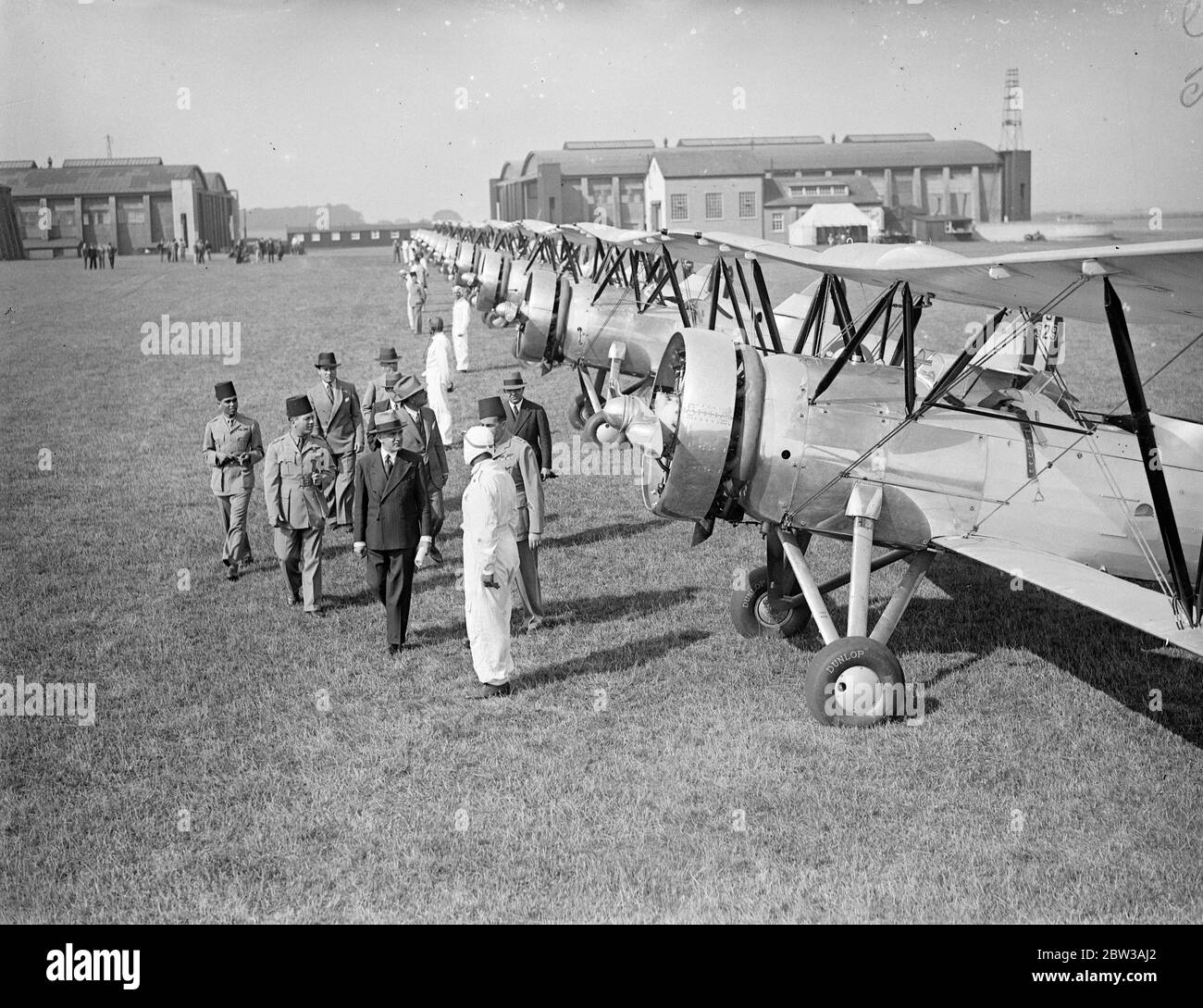 Egyptian air squadron tested at Lympne before formation flight to Egypt . To be used to suppress dope smuggling . A fleet of ten Avro biplanes built in England for the Egyptian Government underwent tests and official inspection at Lympne Aerodrome , Kent , before taking off for a formation flight to Cairo . The planes will be used in Egypt for military purposes and in suppressing the drug traffic . Photo shows the Egyptian Charge d ' Affaires in London , H E Hakki Bey , inspecting the squadron at Lympne . 14 September 1934 Stock Photo