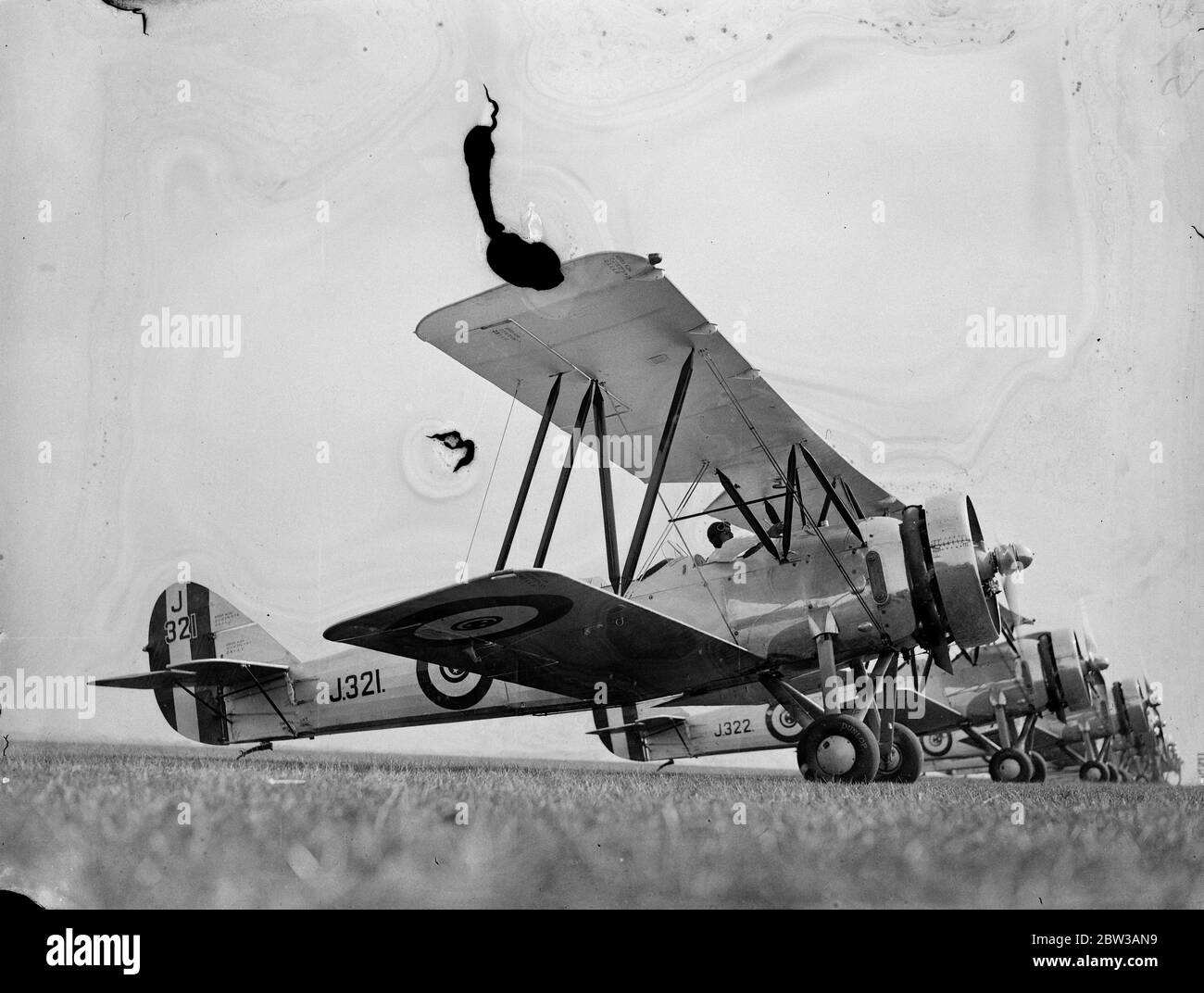 Egyptian air squadron tested at Lympne before formation flight to Egypt . To be used to suppress dope smuggling . A fleet of ten Avro biplanes built in England for the Egyptian Government underwent tests and official inspection at Lympne Aerodrome , Kent , before taking off for a formation flight to Cairo . The planes will be used in Egypt for military purposes and in suppressing the drug traffic . Photo shows the line of planes on the runway at Lympne . 14 September 1934 Stock Photo