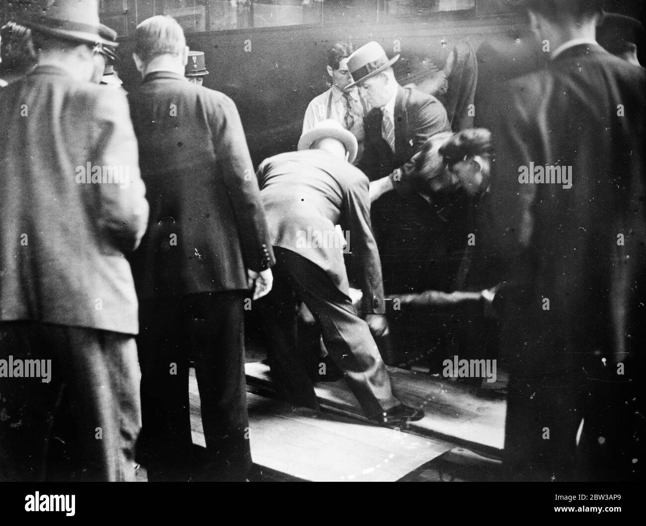 Two men shot dead in the famous ' Blue Train ' on journey from Riviera to Paris . Photo shows the bodies of the two men being removed from the compartment , by the police at the Cure de Lyon , Paris . 27 September 1934 Stock Photo