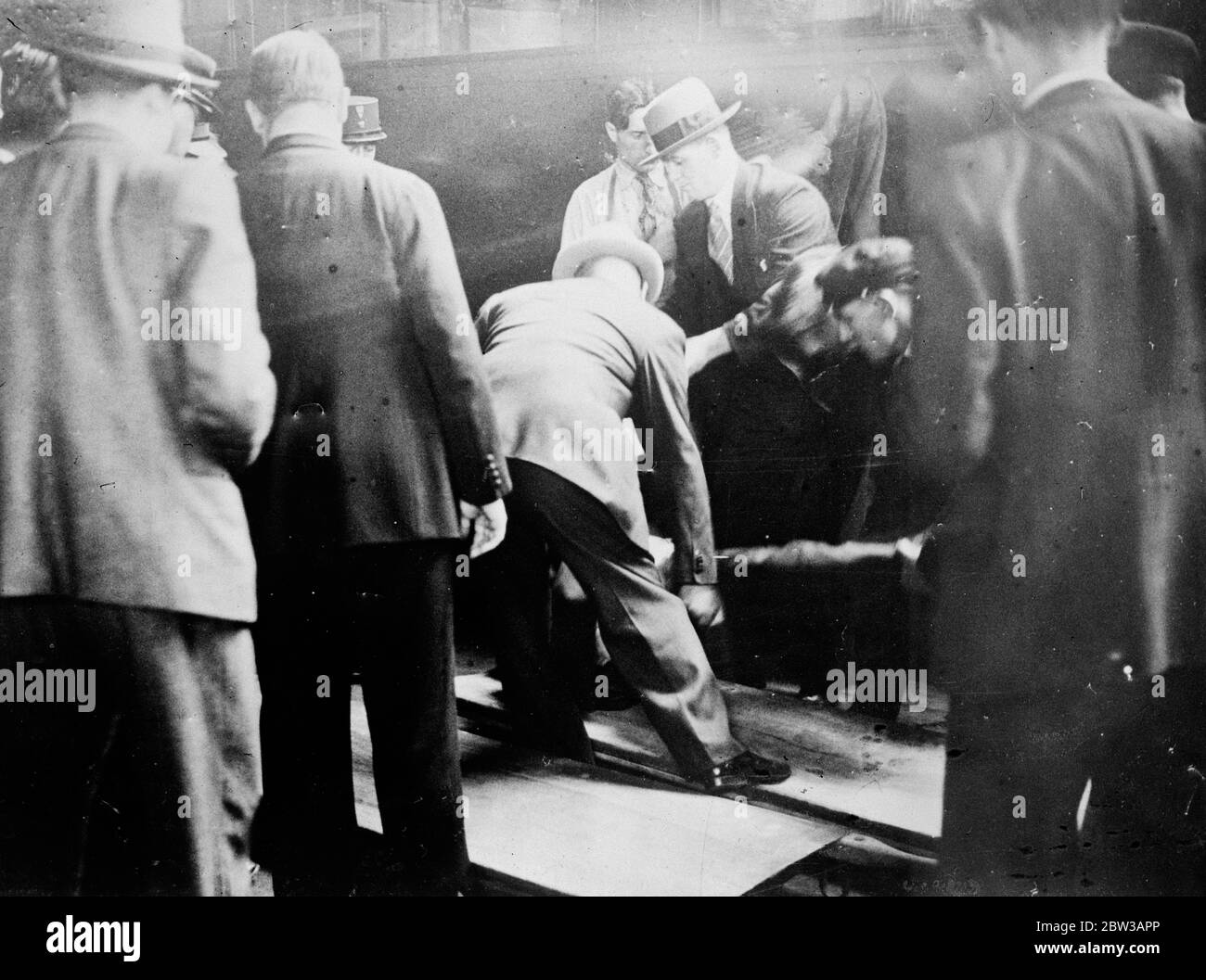 Two men shot dead in the famous ' Blue Train ' on journey from Riviera to Paris . Photo shows the bodies of the two men being removed from the compartment , by the police at the Cure de Lyon , Paris . 27 September 1934 Stock Photo