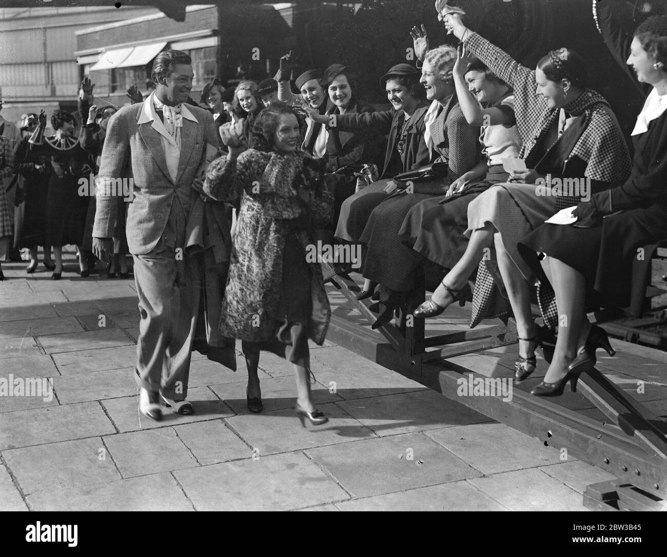 Female admirers cheer Mexican actress , Lupe Velez and her husband , American actor Johnny ( Tarzan ) Weismuller at Paddington Station . 5 October 1934 . Stock Photo