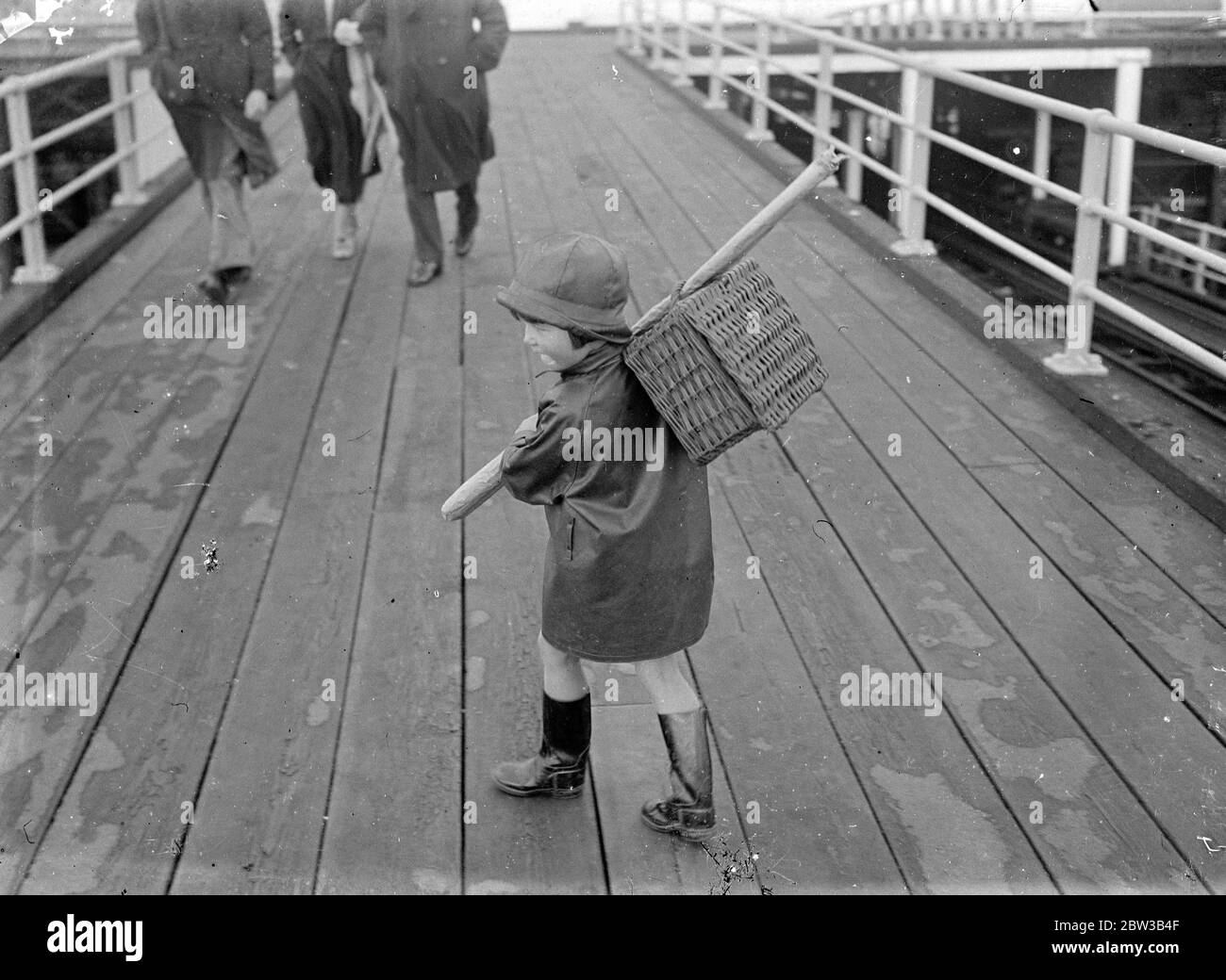A young contestant at the Southend Angling contest makes his way down Southend Pier. October 1934 . Stock Photo