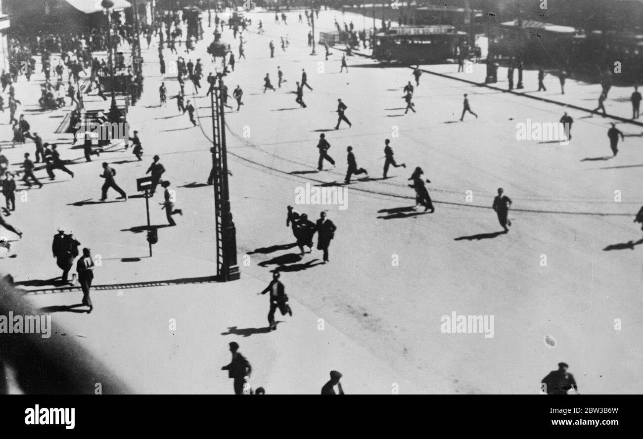 Revolutionaries running from the charge of the Civil Guards in Puerta del Sol , Madrid , Spain . 9 October 1934 . Stock Photo