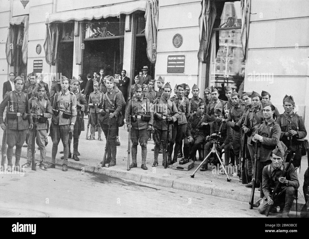 Armed troop on guard outside telephone company in Barcelona , Spain , during the Asturian miners ' strike . 11 October 1934 . Stock Photo
