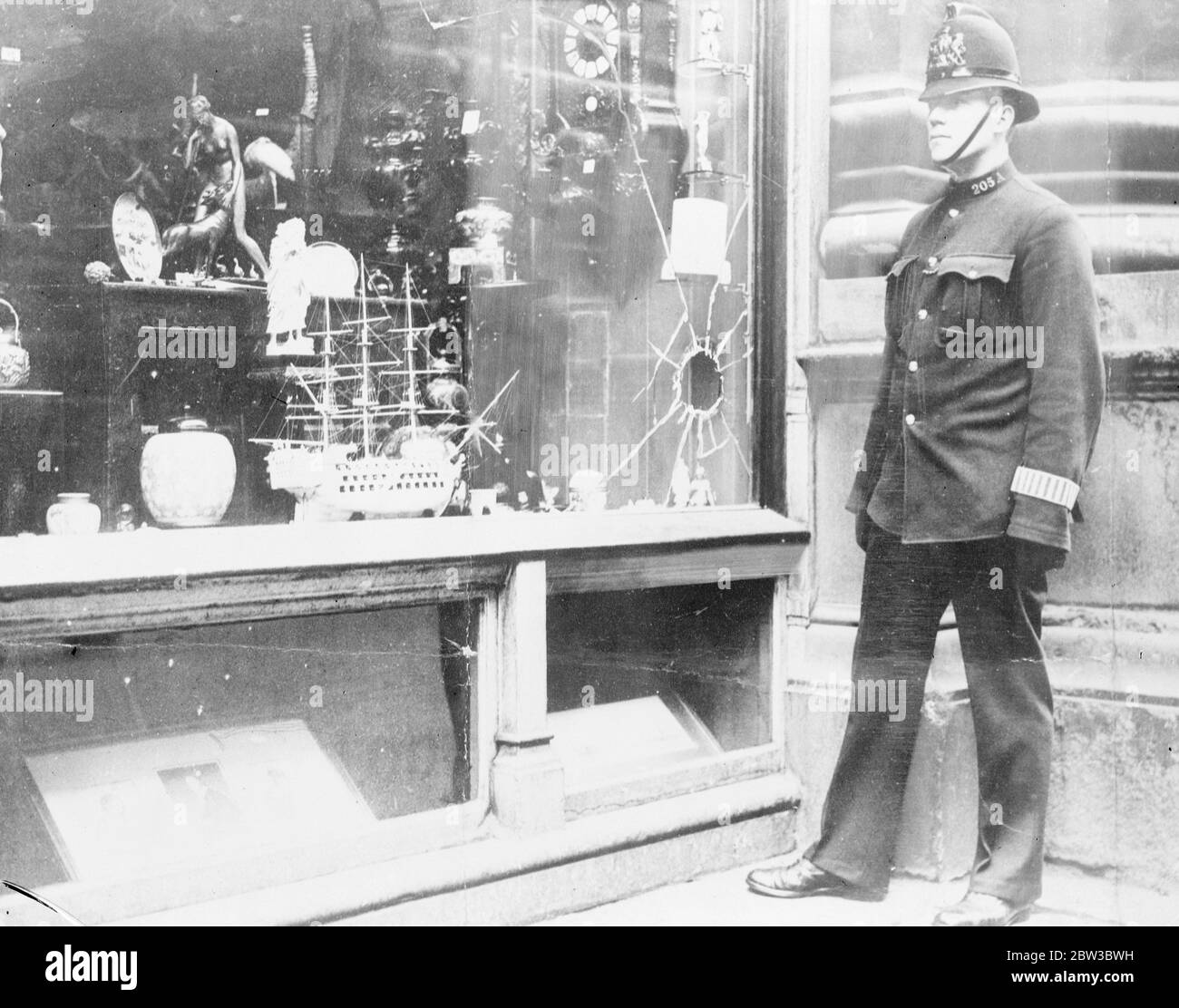 Policeman in front of a broken shop window . October 1934 Stock Photo