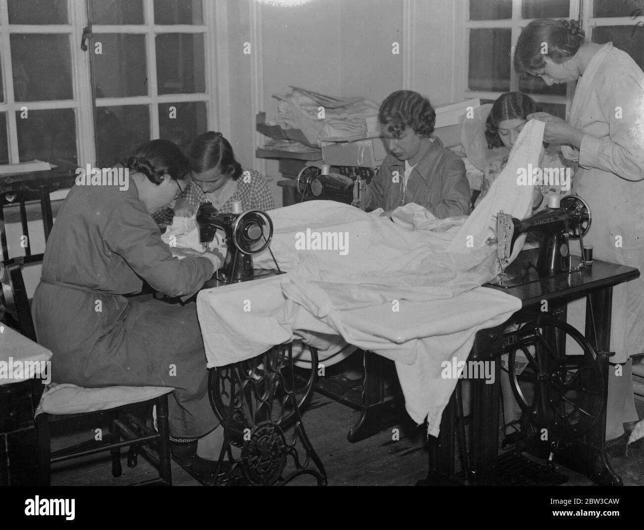 Girls of Royal School of Needlework making bedspread as wedding present for Princess Marina . 14 November 1934 Stock Photo