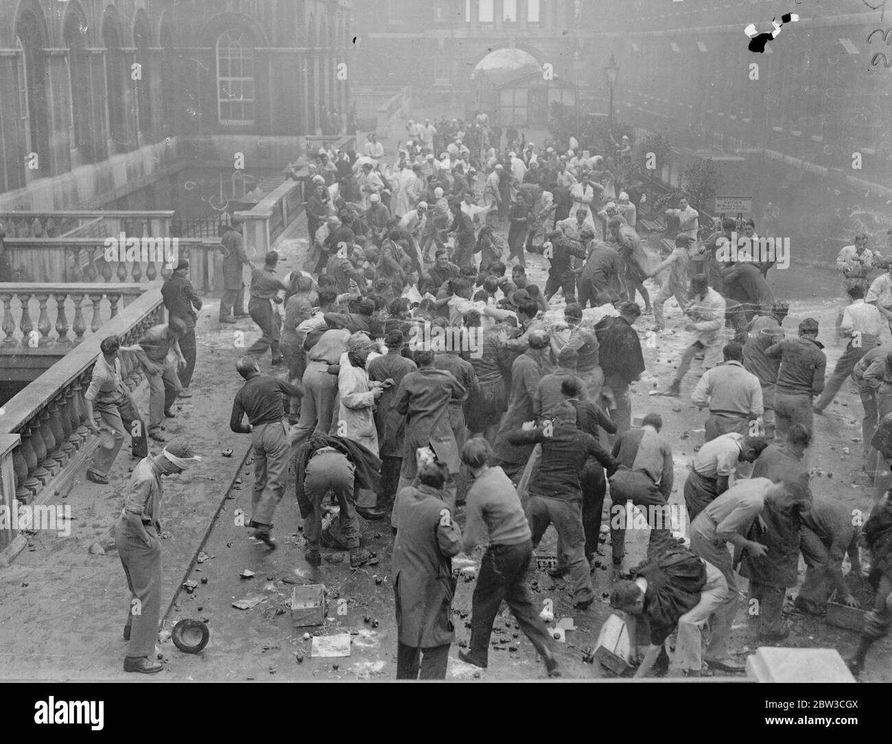 Kings College students during ' Rag ' week with University College in the Strand , London . Mock fight . 23 November 1934 Stock Photo