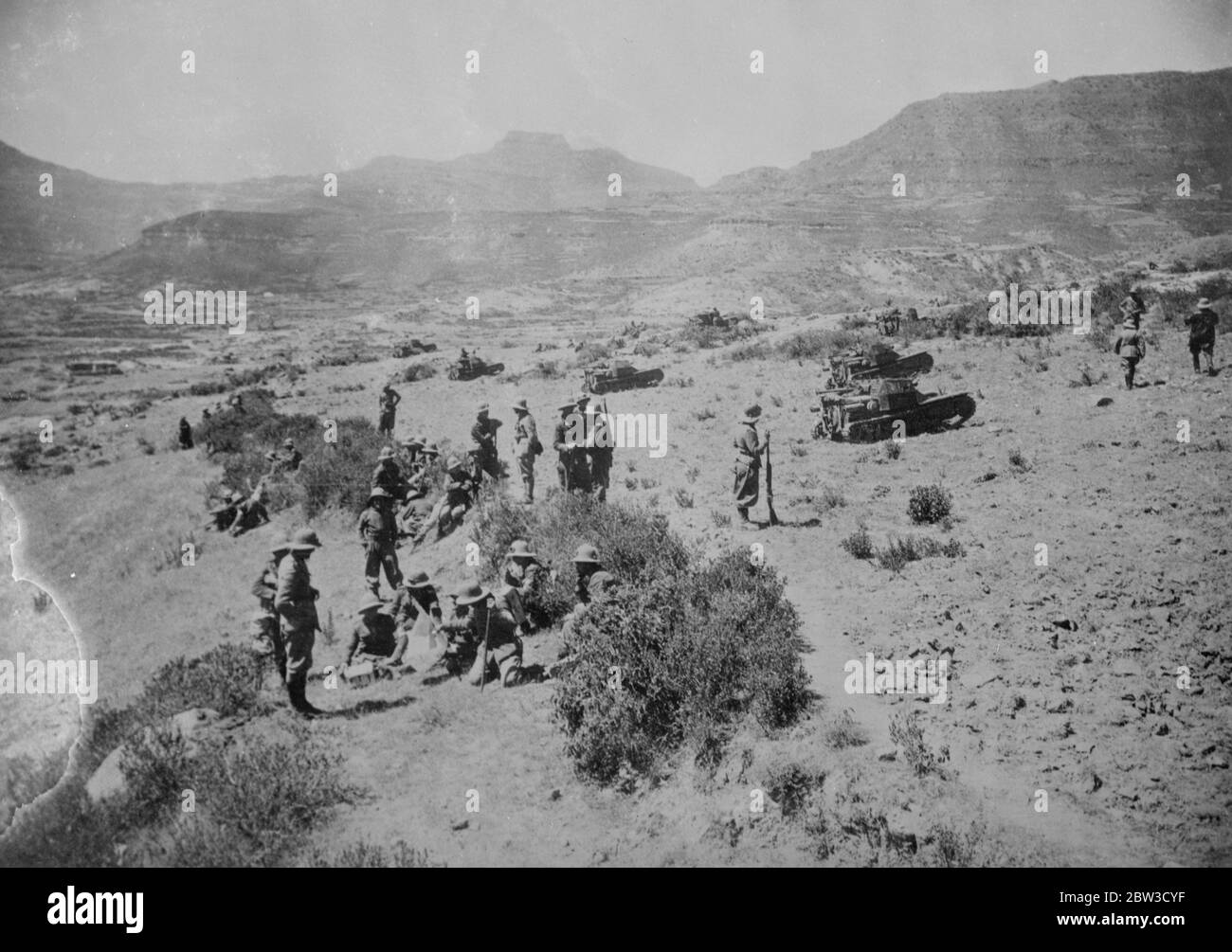 Infantry and tanks in advance . Italian infantry and tanks making a brief pause in the wild desert country beyond Adigrat during their advance . 26 October 1935 Stock Photo