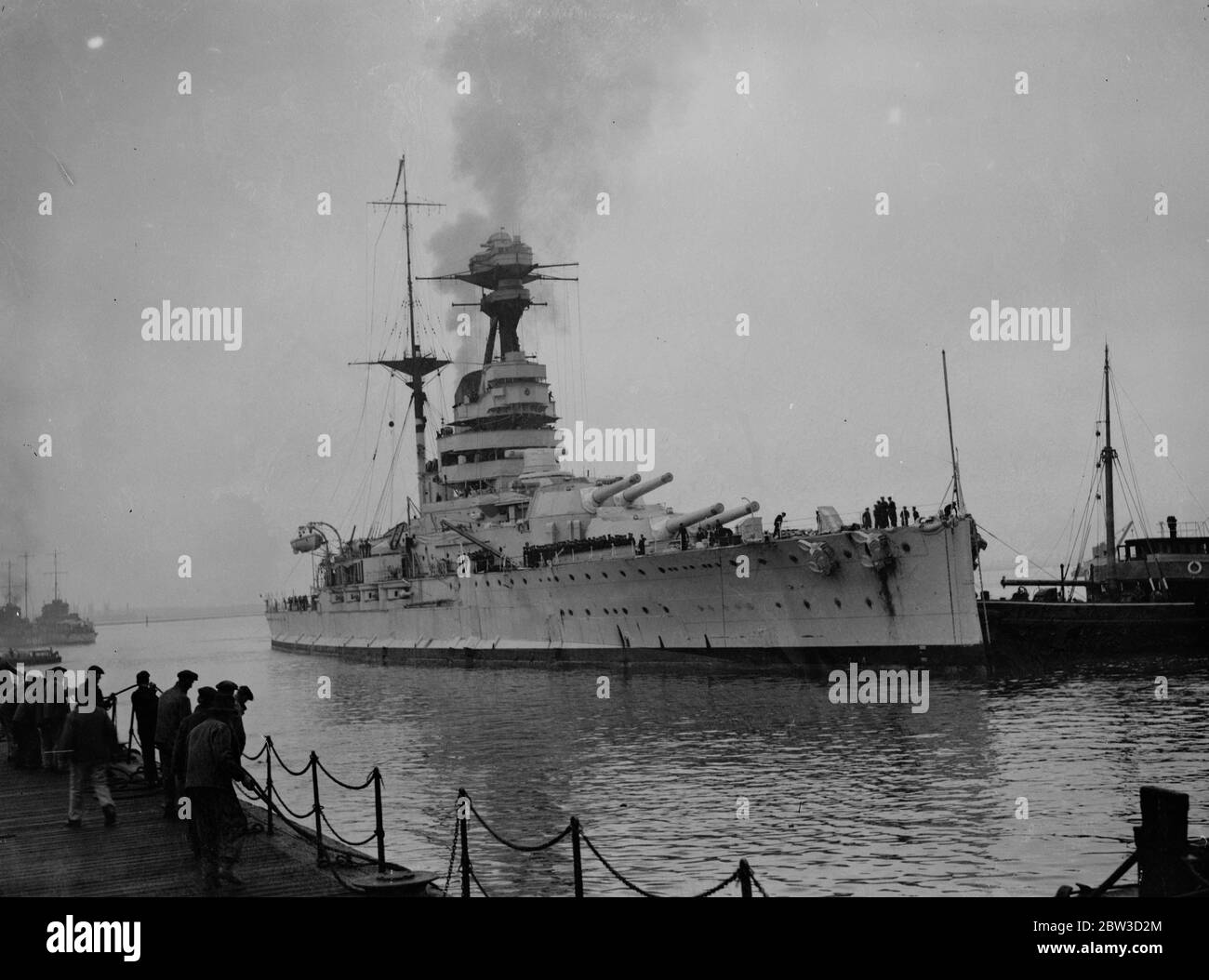Battleship home from the mediterranean . Sailors will spend christmas in England . The 29 , 150 ton battleship HMS Resolution (pennant number 09 ) arrived at Porstmouth from Alexandria after having completed more than two years service on the Mediterranean station . Many sailors from other warships were aboard her as well as her own crew so that they could spend christmas at home . The HMS Resolution bes been relieved by HMS Ramillies ( 07 ) which is of similar class and tonnage . Photo shows , HMS Resolution arriving at Portsmouth . 5 November 1935 Stock Photo
