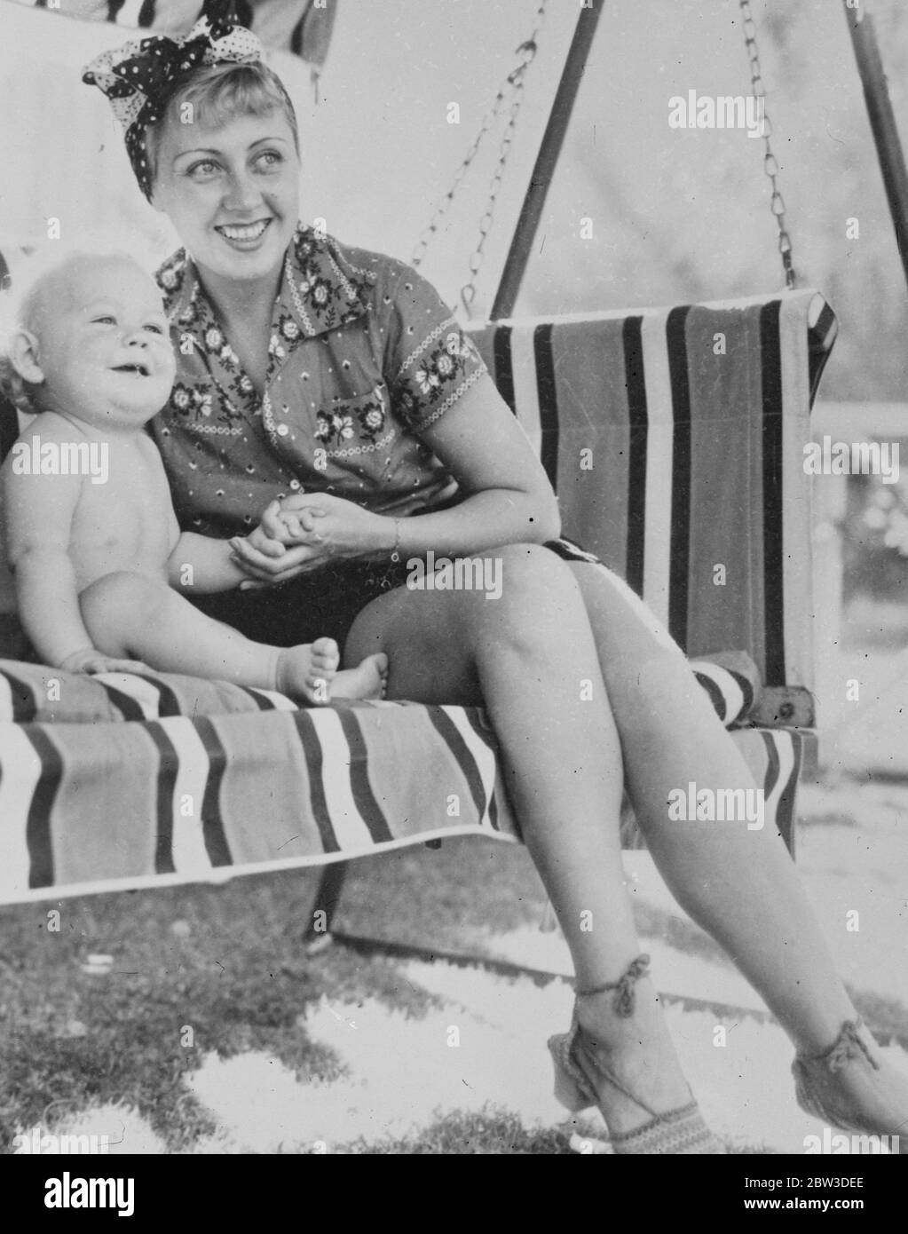 Joan Blondell , the film actress , with her baby son , Norman Scott Barnes , on holiday at Palm Springs , the California resort . Miss Blondell was recently divorced from George Barnes , the cameraman , and was given custody of their baby son . 8 November 1935 Stock Photo