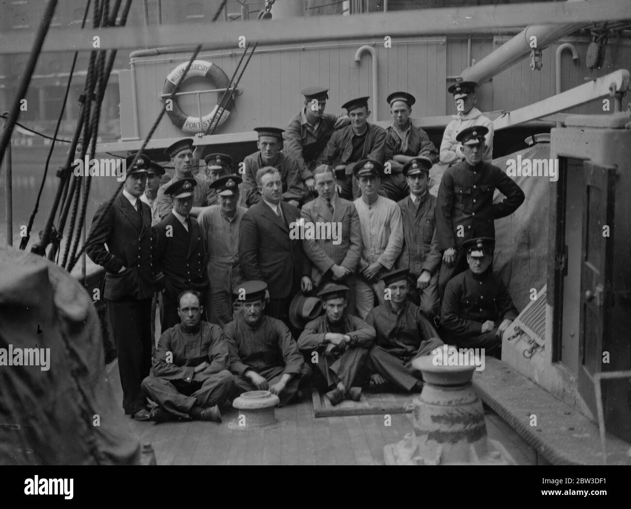 To man  William Scoresby  on Antarctic expedition . The crew of the  William Scoresby  aboard their ship at St Katherine Dock , Lieutenant Boothy , RNR , the captain , is centre ( light suit ) . 18 October 1935 Stock Photo