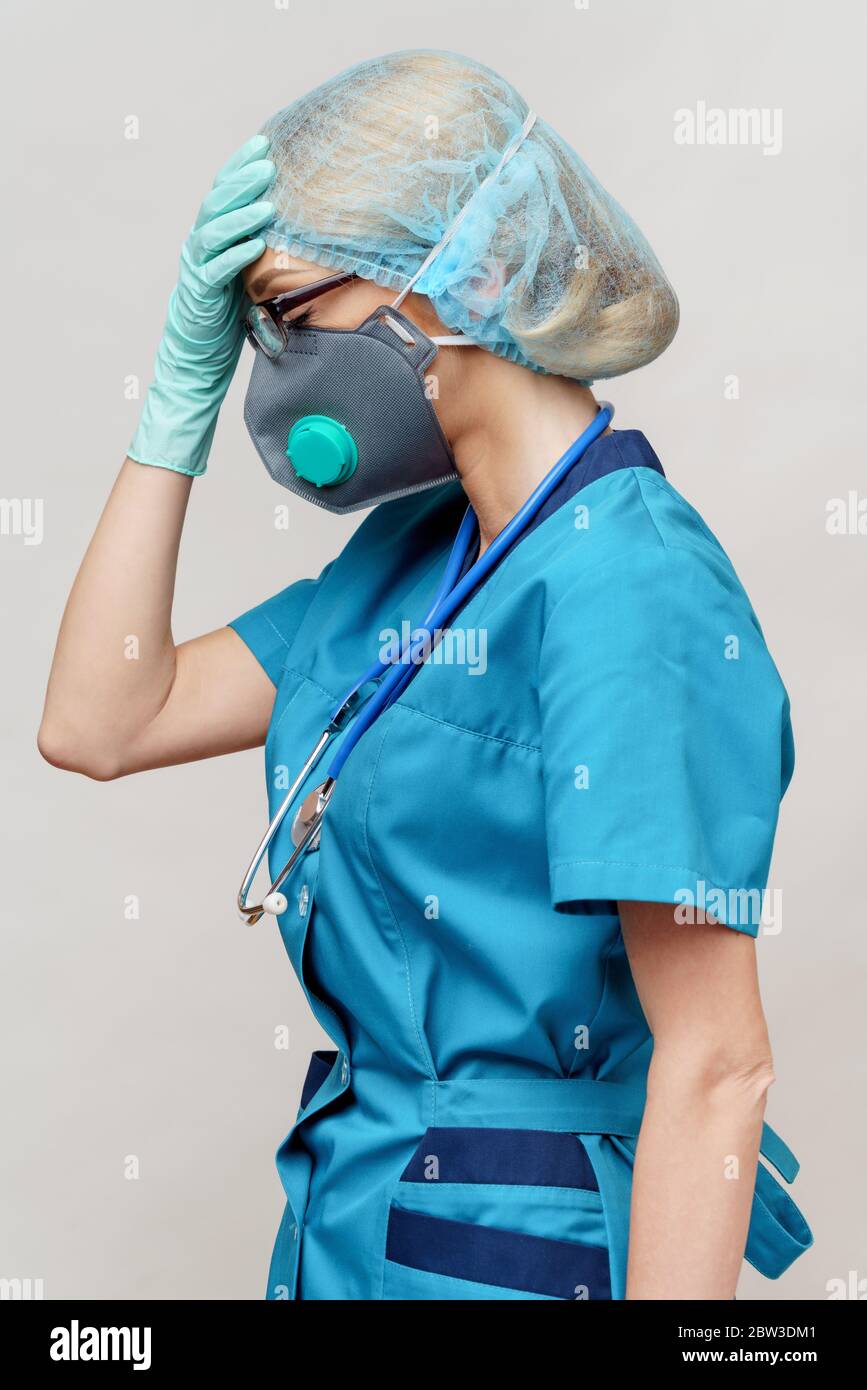 female doctor with stethoscope wearing protective mask and latex gloves ...