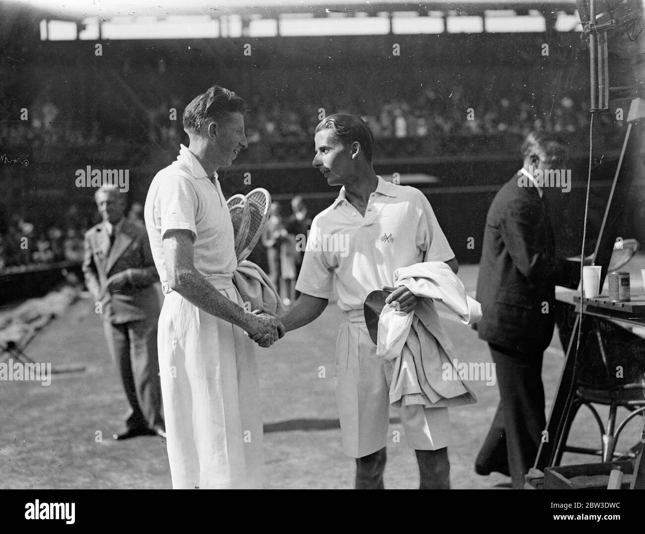 The challenge round of the Davis Cup between Great Britain , the holders and America was opened at Wimbledon Bunny Austin of Great Britain played and defeated Donald Budge of America . Photo shows the two players shaking hands after the match . 27 July 1935 Stock Photo