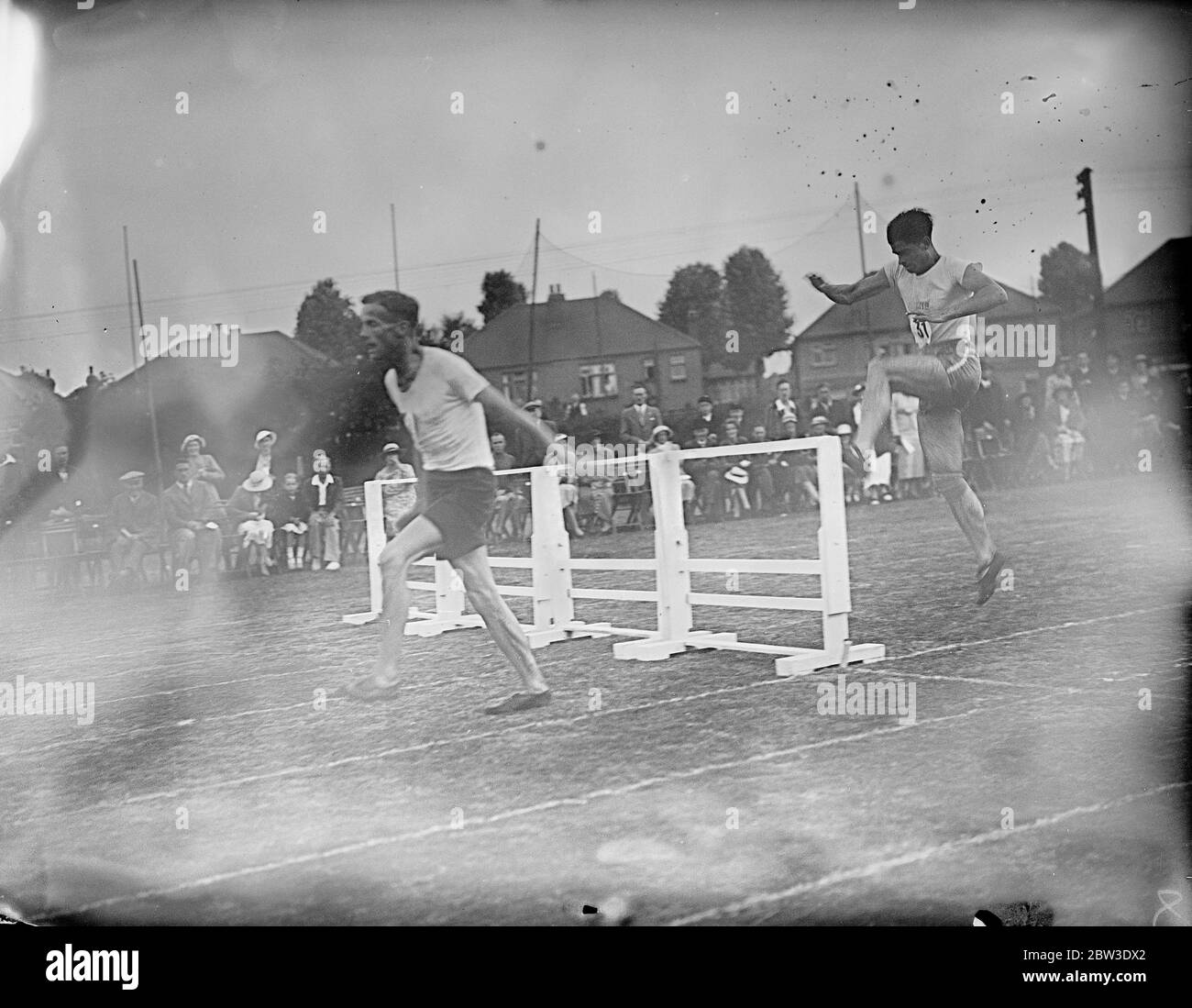 Paris schoolboy athletes meet London team for first time at Rutlish school , Merton , London . Photo shows , D E Martin leading Louis Gallior in the hurdles . 26 July 1935 Stock Photo