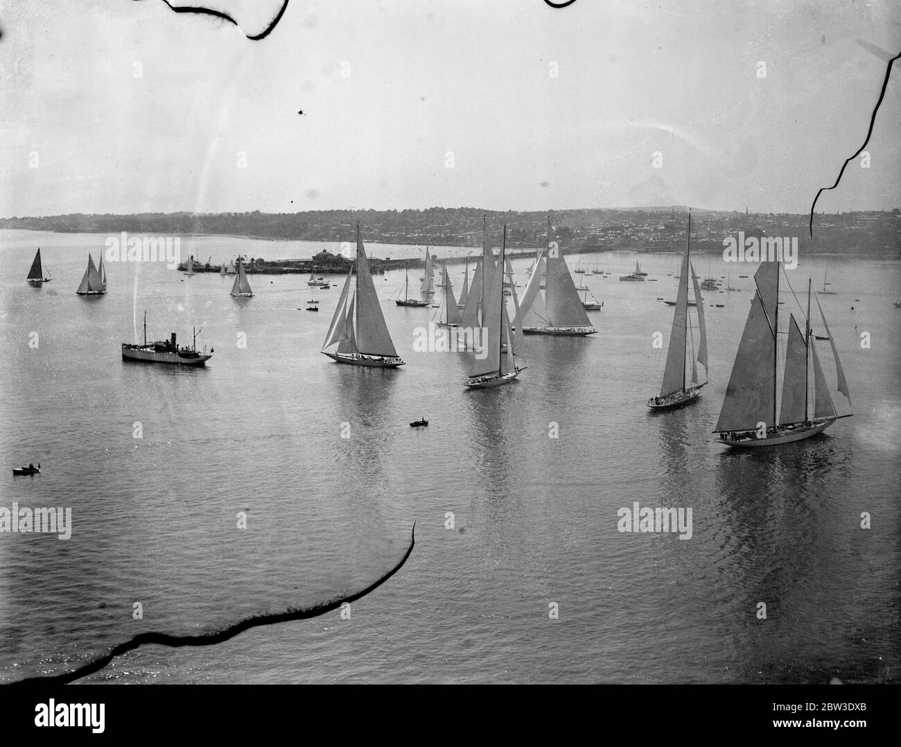 The King ' s half century old yacht Britannia ( black hull on left ) competed againt the 5 year old American J-Class yacht Yankee sailing and other famous yachts , when the races of the Royal Thames Yacht club were held of Ryde on the Isle of Wight . 31 July 1935 Stock Photo