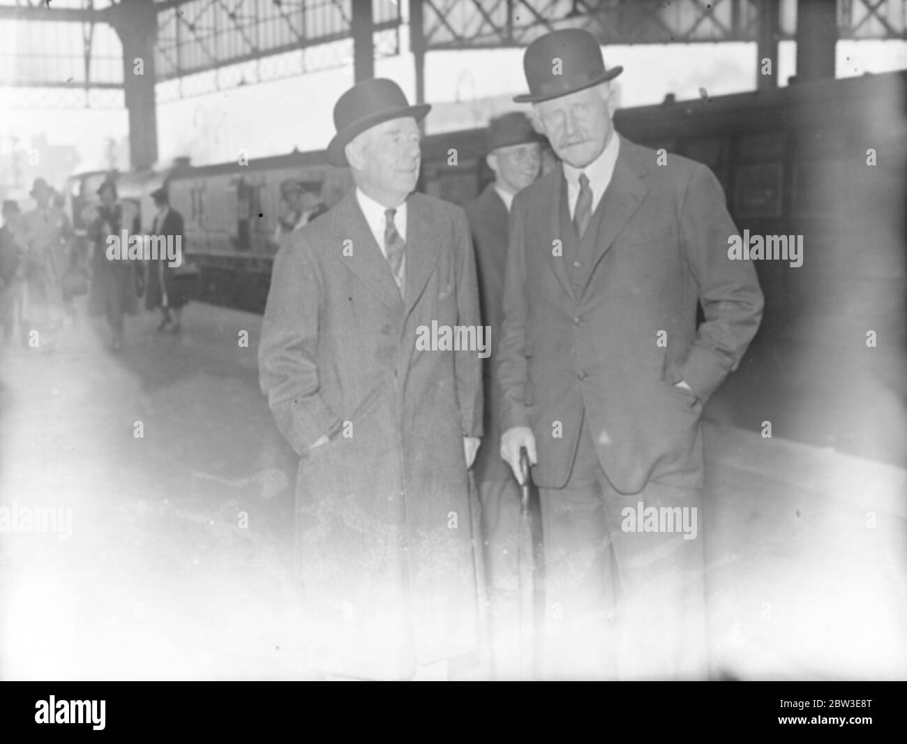 Thomas Lamont ( left ) , famous American banker , arrives . A partner in the J P Morgan Company arrived at Waterloo Station , London on the Bremen boat train . 19 June 1935 Stock Photo