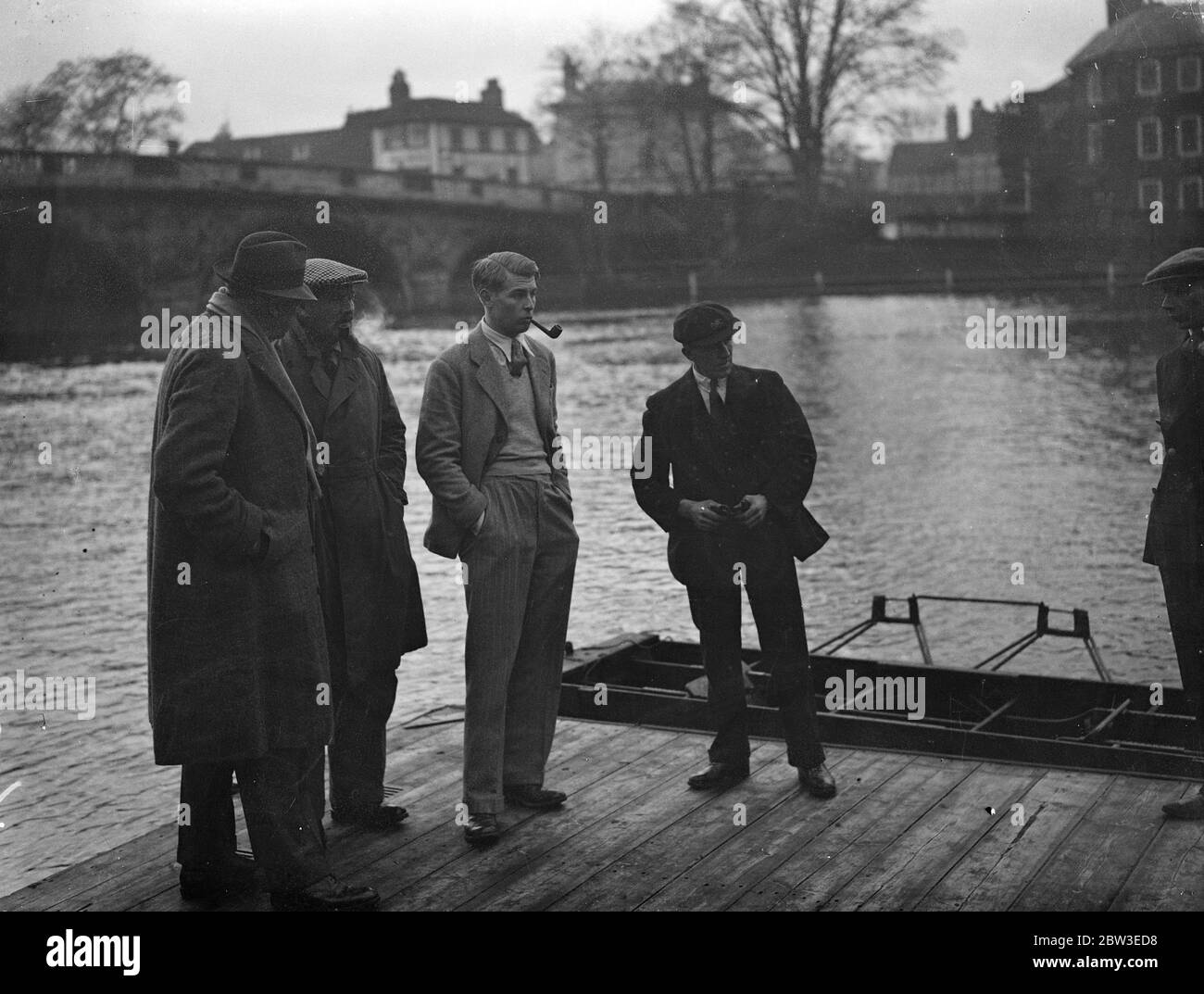 Oxford crew train for boat race under the critical eyes of President and coaches . Left to right - F Escombe and Haig Thomas , the two Oxford coaches , with the President , M H Moneley , watching the crew at work on the river . 14 January 1935 Stock Photo