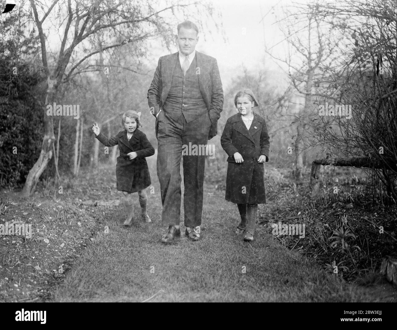 Englishman to count the votes of the Saar Plebiscite . Mr Ben Greene has been appointed Deputy Chief Returning Officer for the Saar Plebiscite . Photo shows ; Mr Ben Greene in his garden with his children . 30 December 1934 Stock Photo
