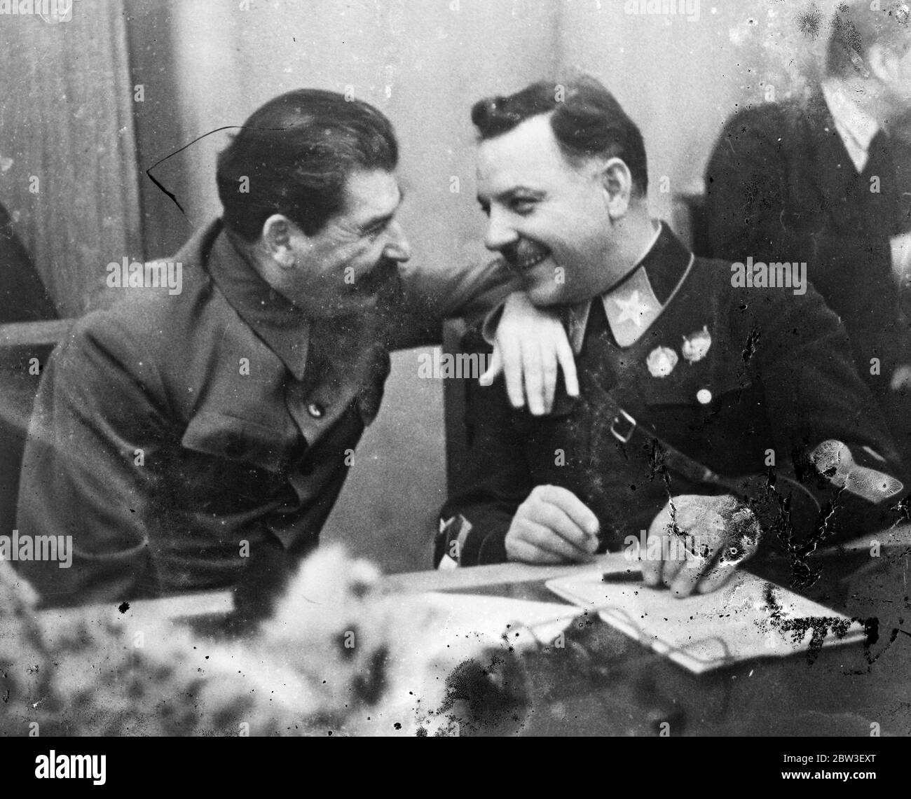 Stalin ' s little joke . M Stalin , the Soviet dictator , resting his arm on the shoulder of K E Veroshilov , Defence Commissar , as they laughed together at a collective farmers conference in Moscow . M Voroshilov is making his first appearance in the uniform of a Marshal of the Soviet Union . , the rank to which he was recently promoted . This uniform is more ornate than is used in Russia . It bears a large gold embroided star on red collar patches and a large gold embroidered star and gold stripes on the cuff . 27 December 1935 Stock Photo