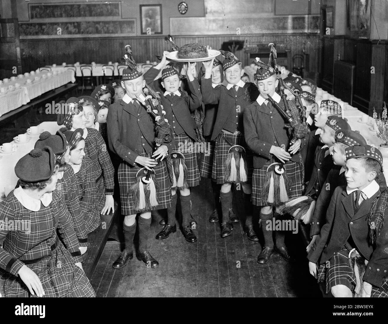 Piping in the Christmas pudding at Royal Caledonian Schools . Piping in the Christmas pudding at the Royal Caledonian Schools , Bushey . 20 December 1935 Stock Photo