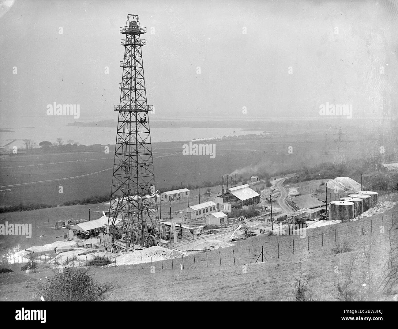 Oil boring about to begin in Portchester . Preparations are almost completed at Portchester , Hampshire , for the start of oil boring operations . Search is being made for a great oil lake which experts believe to lie under Southern England . Photo shows , the oil derrick and buildings nearly completed at Portchester . 14 March 1936 Stock Photo