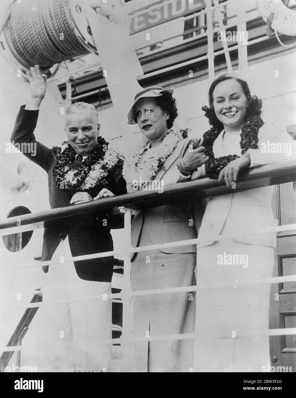 Charles Chaplin , now engaged to Paulette Goddard , lunches with Bernard Show in Honolulu . Charles Chaplin , famous film comedian , who is now rported definitely engaged to Paulette Goddard , his leading Lady in in ' Moddern Times ' , lunched with Mr George Bernard Shaw in Honolulu where Chaplin made a stay with his fiancee and her mother , Mrs Alta Goddard , during their holiday tour . It is stated that Chaplin kept GBS waiting for 35 minutes in front of the Royal Royal Hawaiian Hotel and that Mr Shaw sputtered and fumed with rage ! Photo shows , Charles Chaplin , Paulette Goddard ( right ) Stock Photo