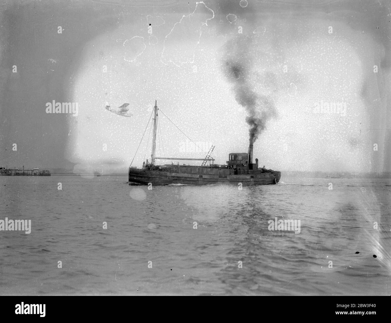 Short S.8 Calcutta ( G-EBVG ) '' City of Alexandria of the the Imperial Airways flying over a small ship . Stock Photo