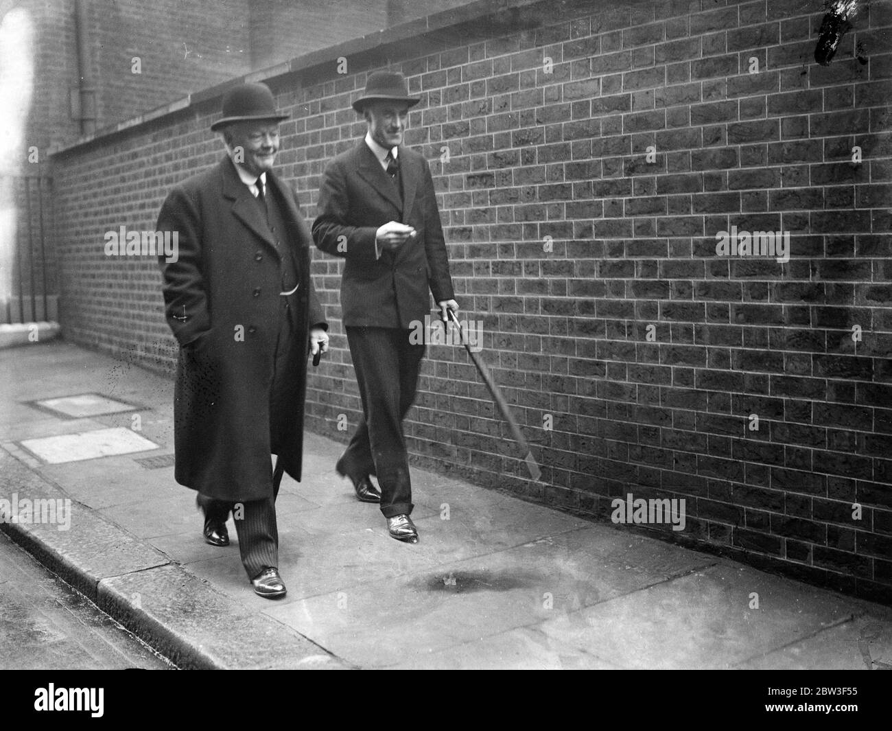 Ministers leave after Cabinet meeting . A Cabinet meeting was held at Downing Street when the situation brought about by Germany ' s reoccupation of the Rhineland was considered . Photo shows , Lord Hailsham , the Lord Chancellor ( left ) and Lord Swintop , the Air Minister , leaving after the meeting . 9 March 1936 Stock Photo