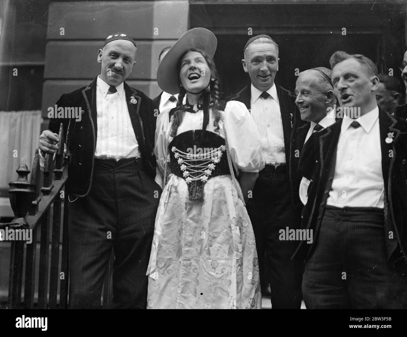 Swiss yodellers arrive in London . To sing at Albert Hall . A party of Swiss Yodellers , dressed in national costume arrived at Victoria STation to sing at the Royal Albert Hall tomorrow ( Saturday ) . They were welcomed by Mr C B Paravicini , the Swiss Minister in London . There were 16 members . Photo shows , Gritli Wenger a singer from Thun on Lake Thun , giving London a taste of her skill . 6 March 1936 Stock Photo